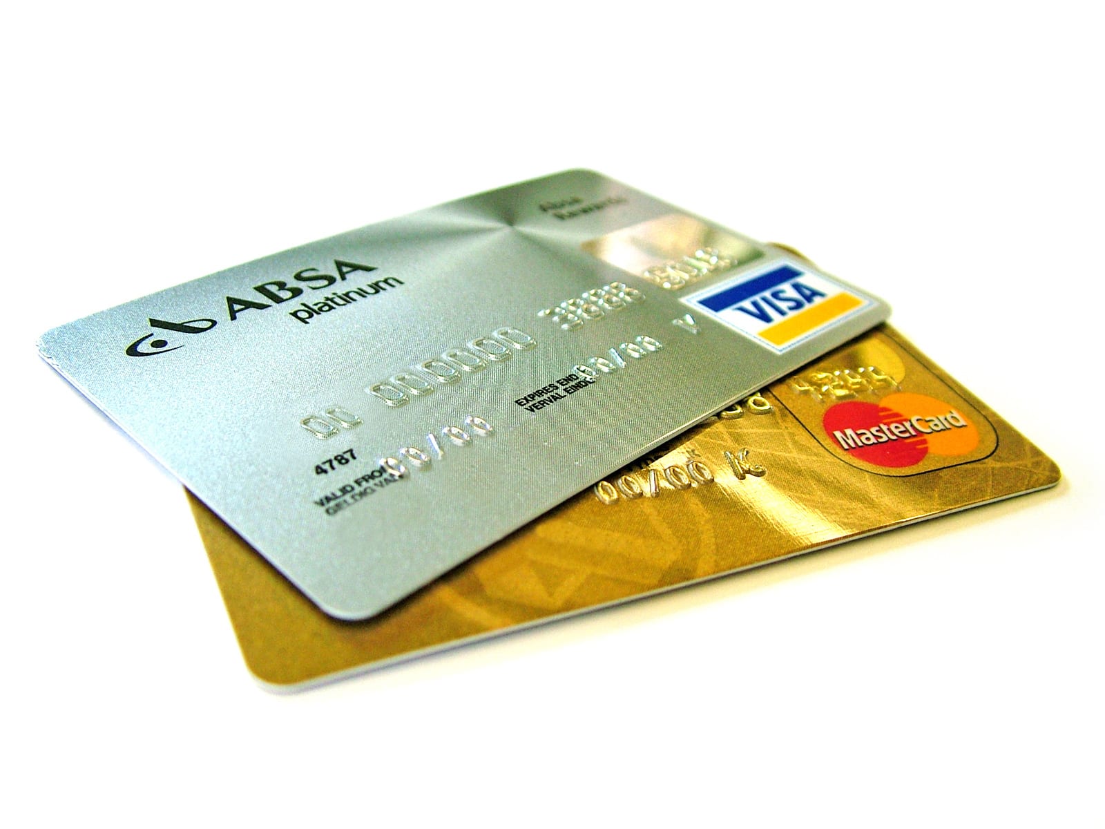 A Visa card and a gold Mastercard overlapping on a white background