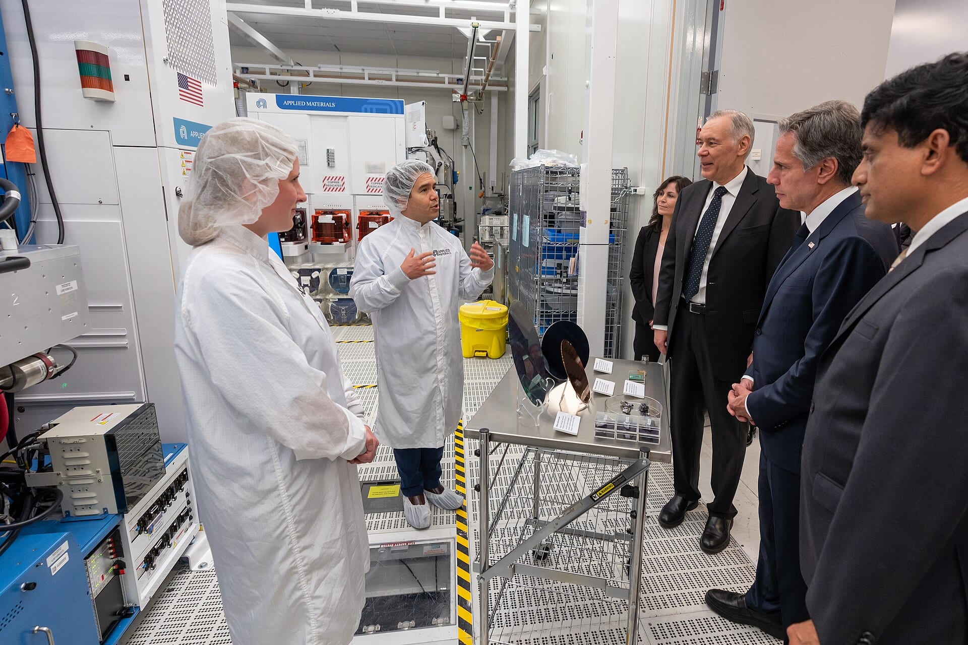 Applied Materials engineers in cleanroom garments demonstrate wafer fabrication tools and wafers to US Secretary of State Antony Blinken at the company's Maydan Technology Center in Sunnyvale, California