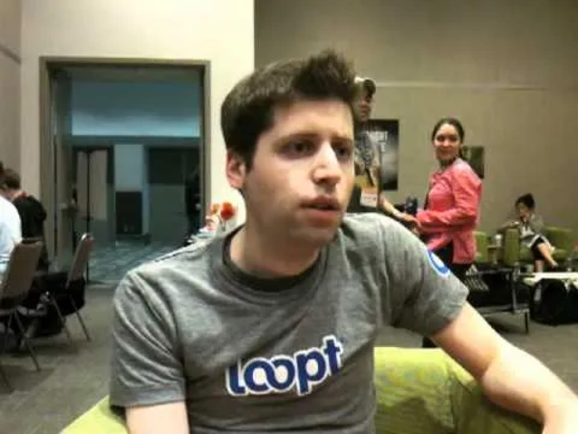 Sam Altman, chief executive of OpenAI, speaking at a conference while wearing a Loopt T-shirt.