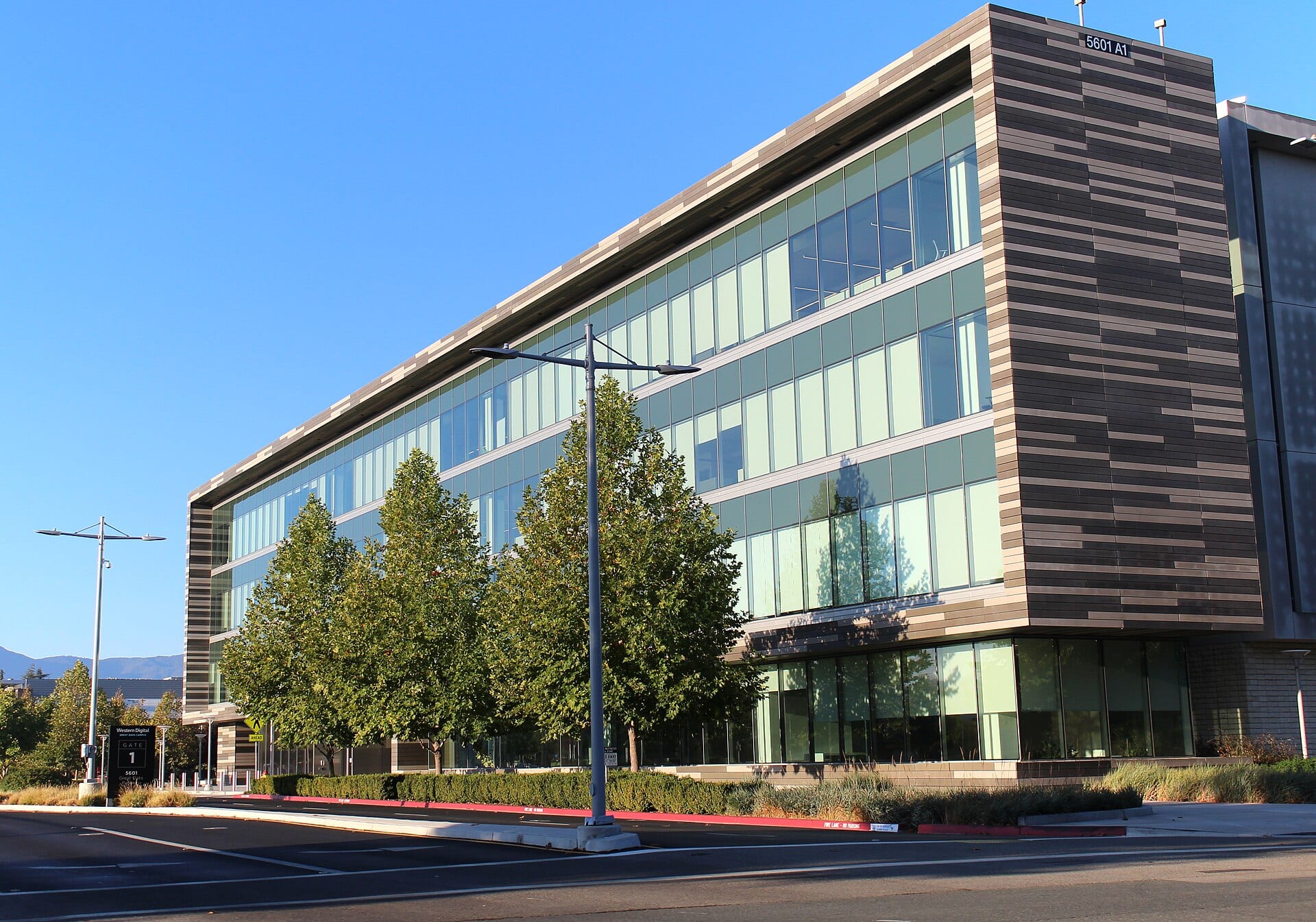 Western Digital's headquarters in San Jose, California, a glass and stone office building with the company's name on the gate sign