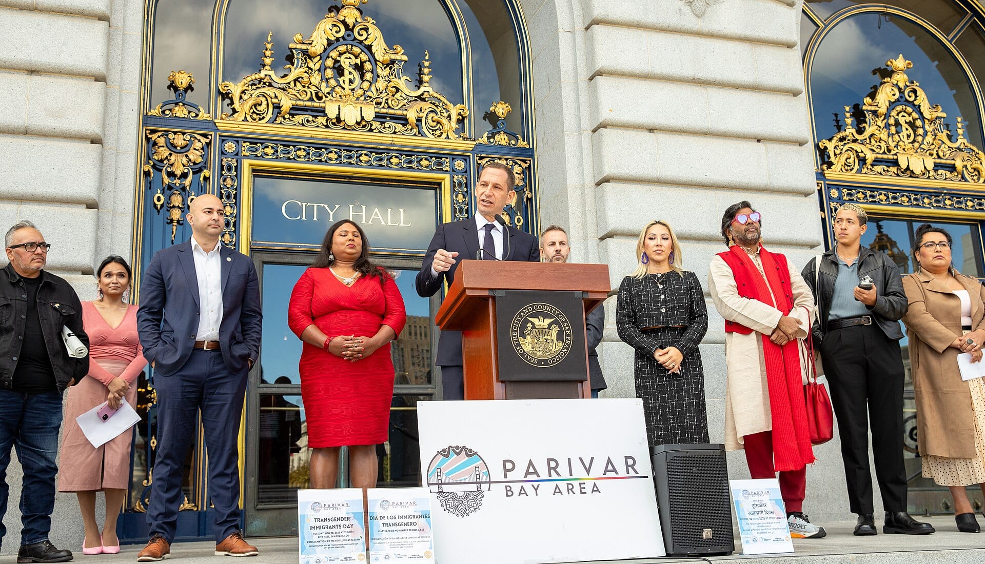 San Francisco Mayor Daniel Lurie speaks at a podium outside San Francisco City Hall
