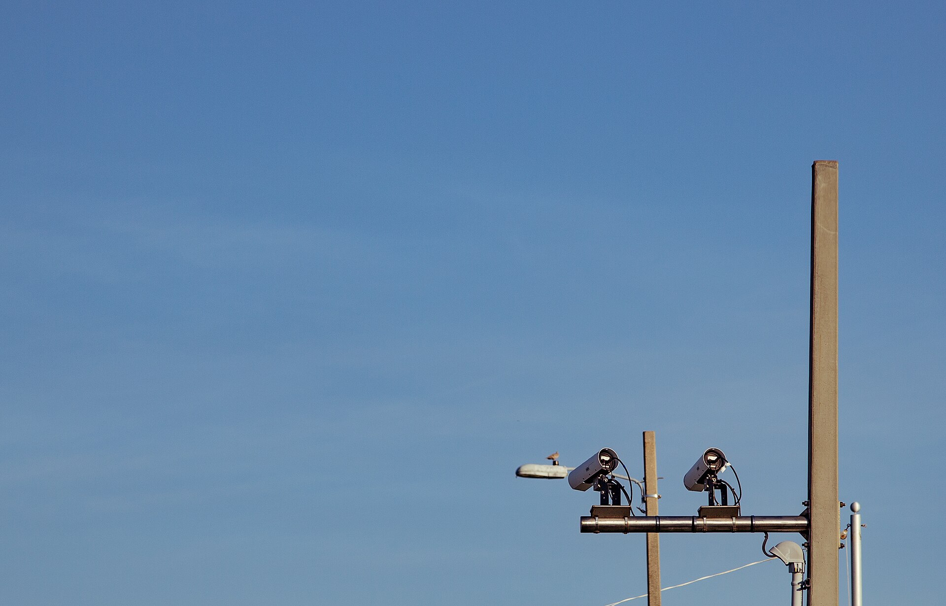 Two license plate reader cameras mounted on a pole over a road in Pensacola, Florida