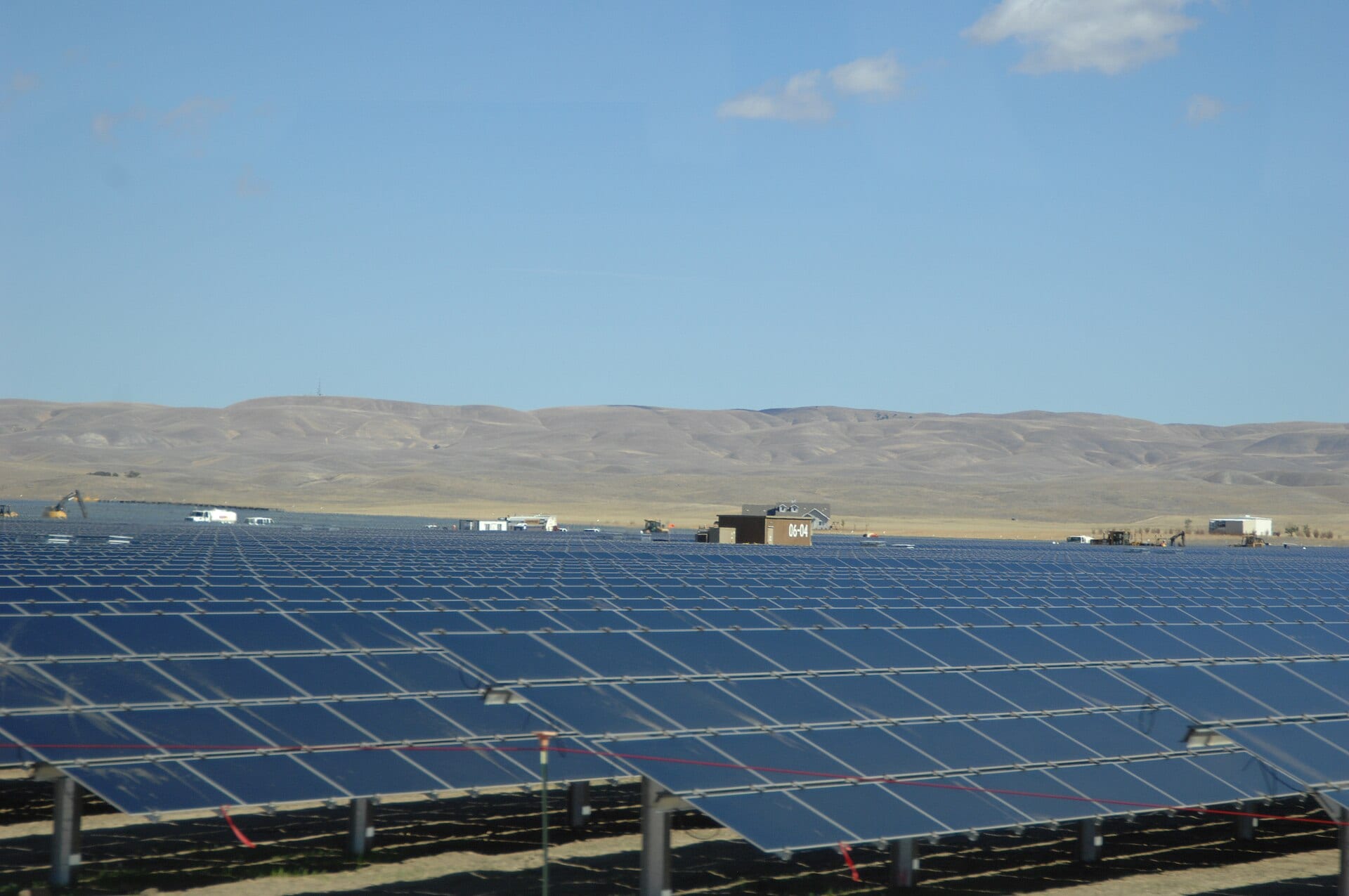 Rows of dark thin-film solar modules stretch toward dry hills at the Topaz Solar Farm in California's Carrizo Plain