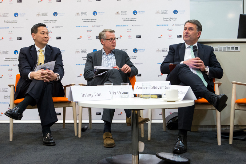 Irving Tan seated on a panel at the Crawford Australian Leadership Forum, his name card on the table in front of him