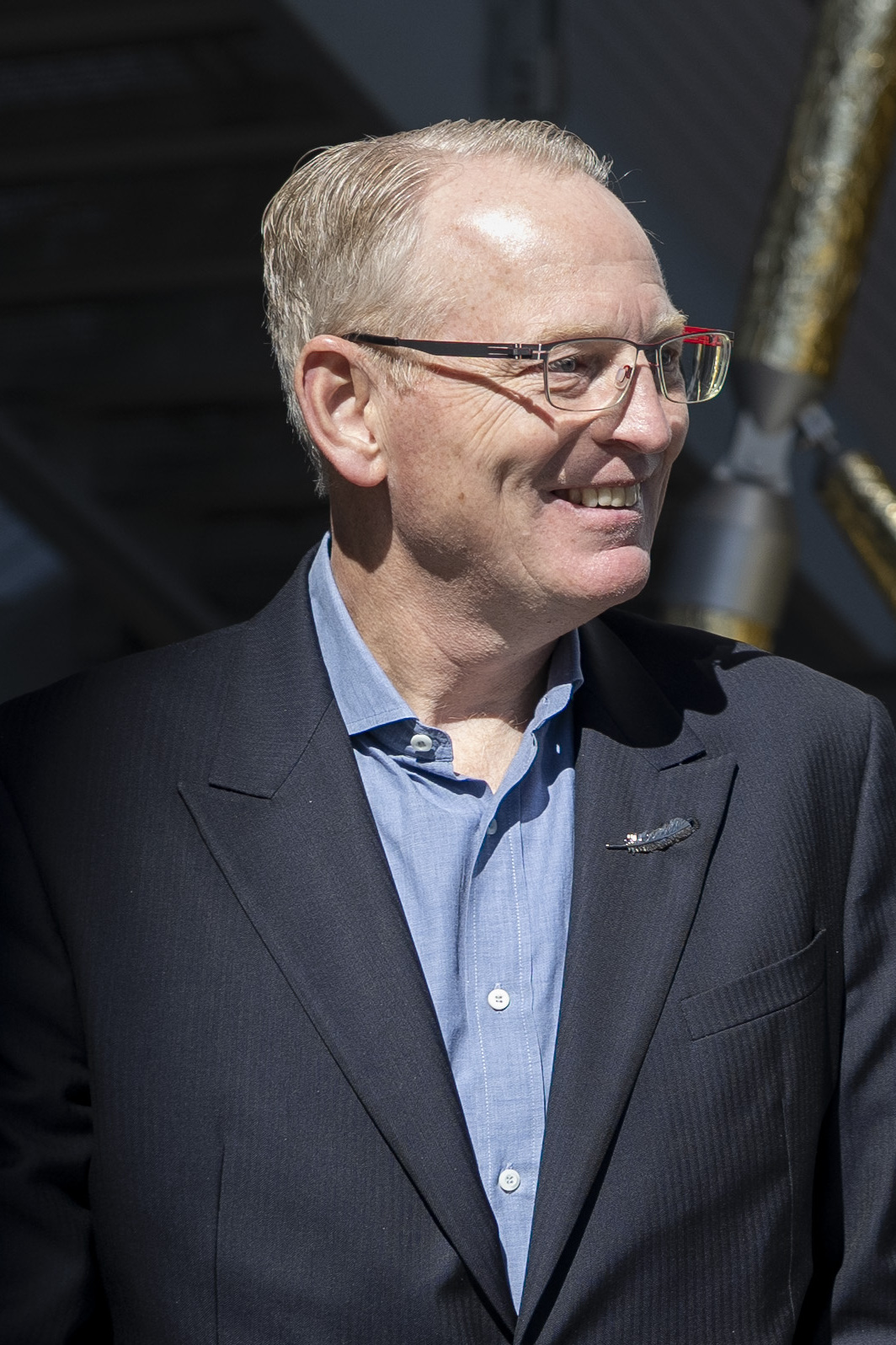 Dave Limp, chief executive of Blue Origin, smiling in a navy blazer with the company's feather pin on the lapel