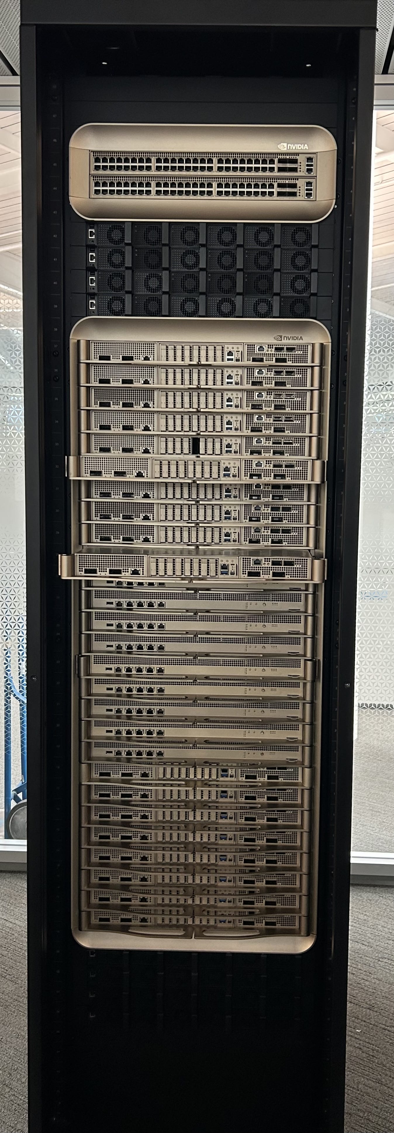 An Nvidia DGX GB200 rack photographed full height, the previous-generation NVL72 system class that Cognition's Vera Rubin benchmark used as its baseline