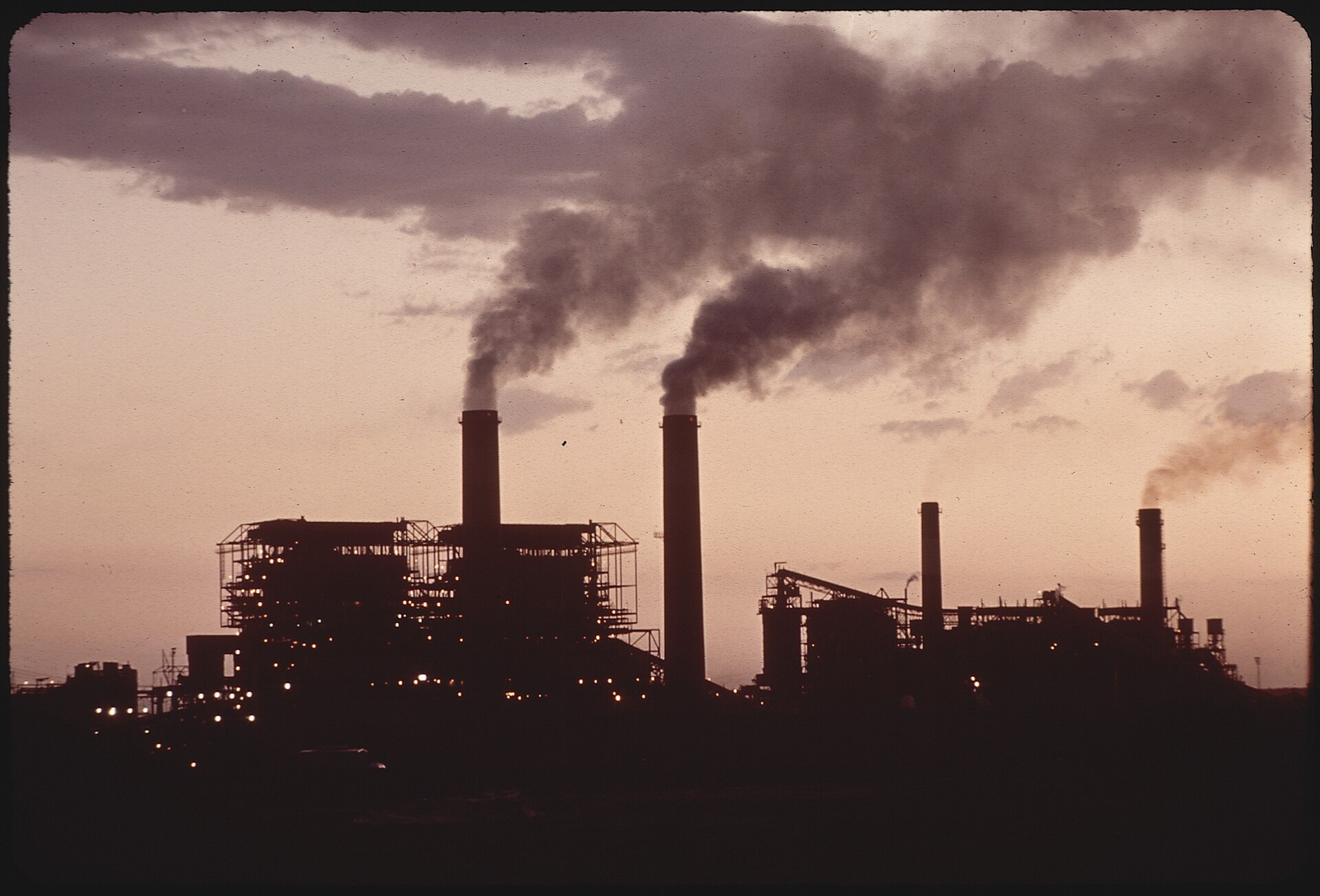 Four Corners Power Plant seen across its cooling pond in June 1972, smoke rising from several stacks