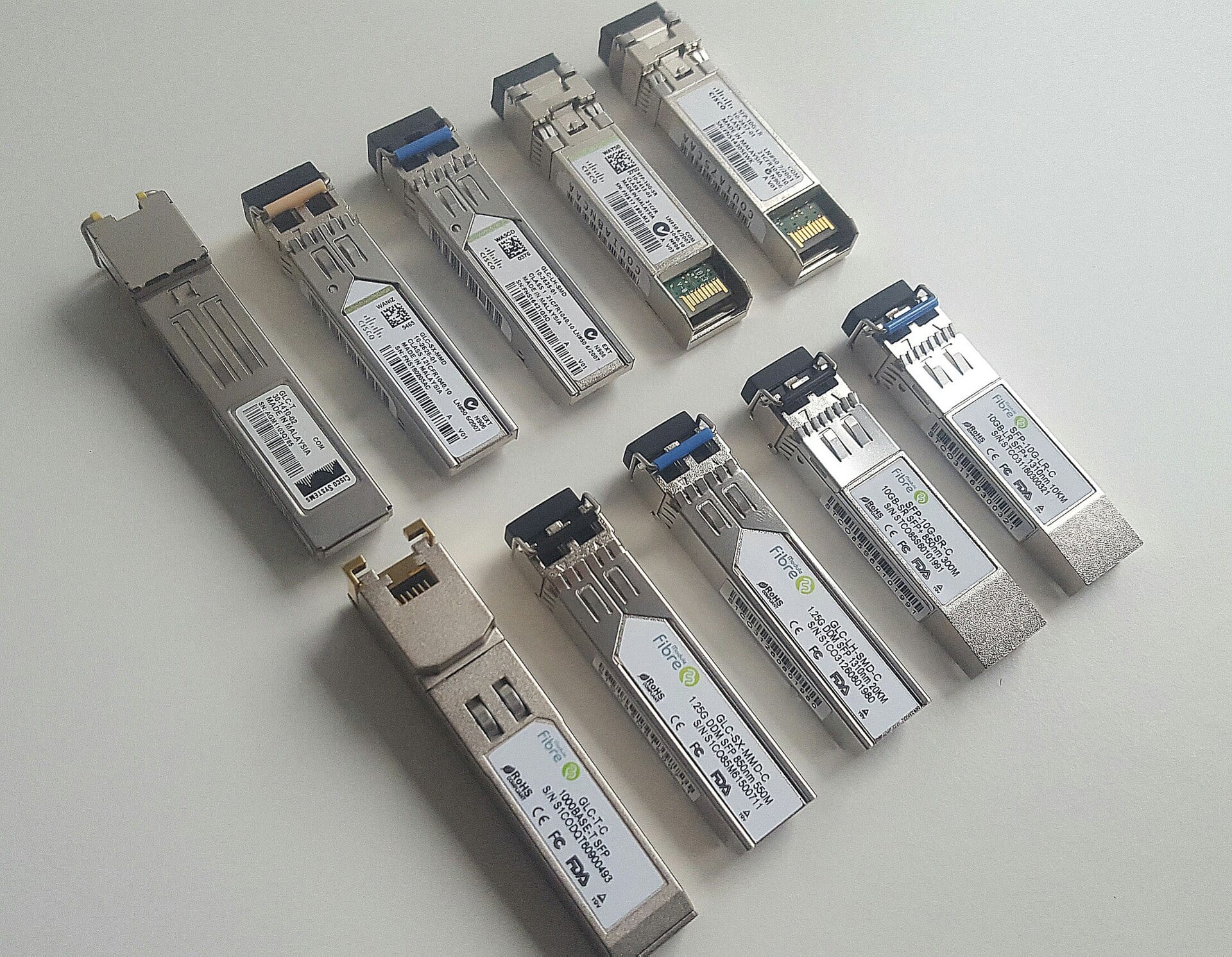 A tray of assorted optical transceiver modules of the type used in data center network links