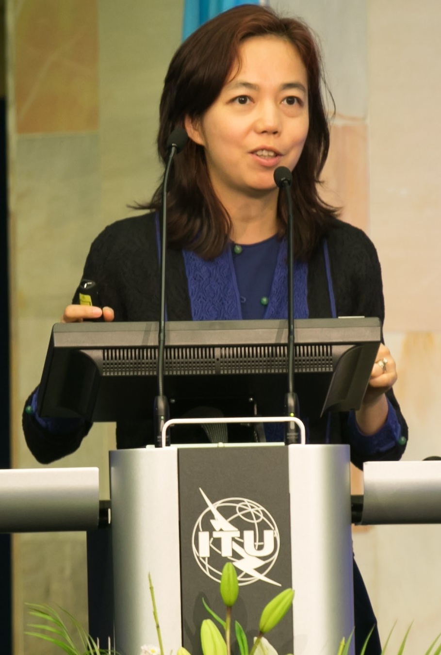 Fei-Fei Li speaking at an ITU podium during the AI for Good summit in Geneva, 2017