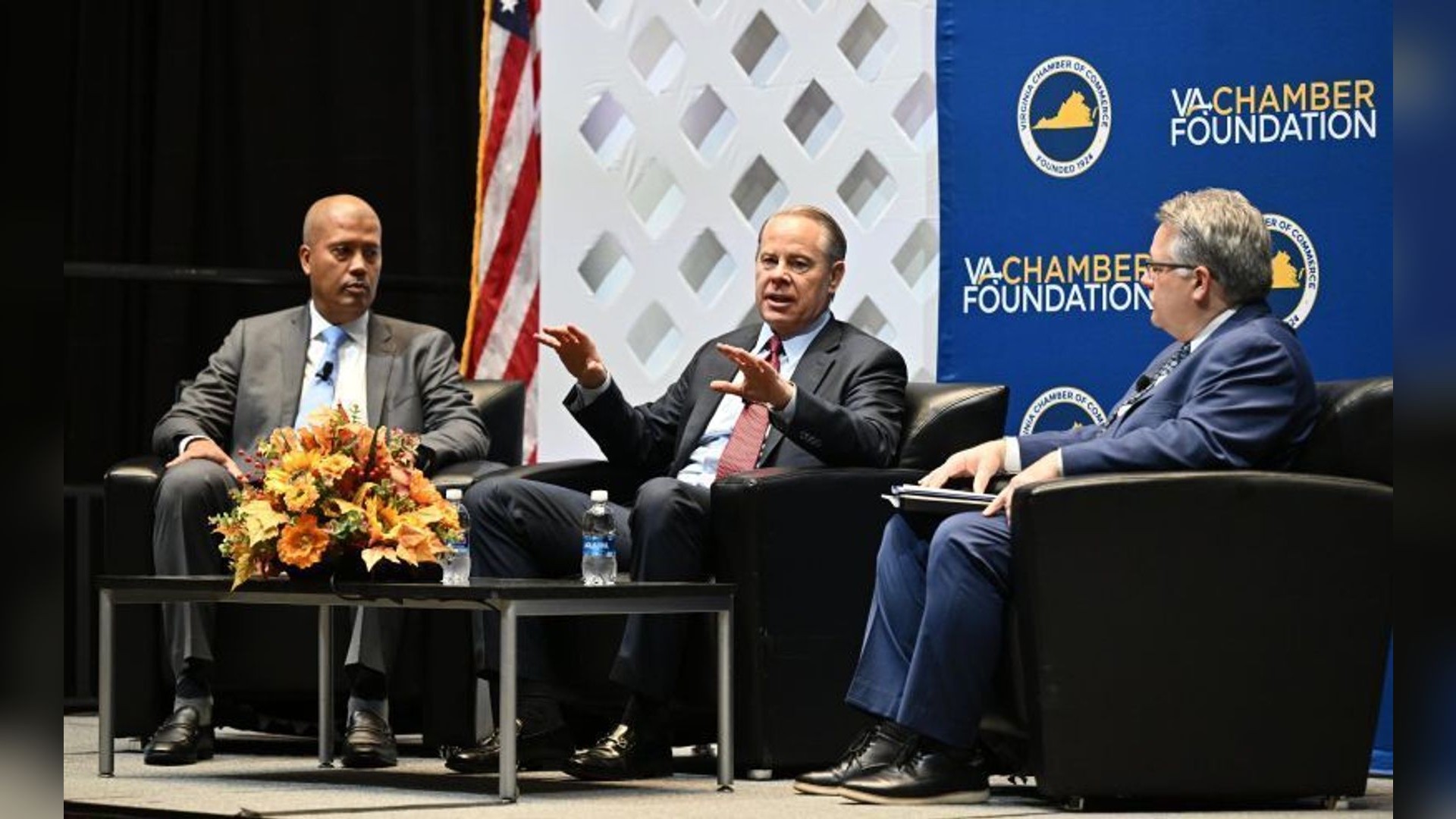 NextEra Energy chief executive John Ketchum speaks at the Virginia Forum on Infrastructure beside Dominion Energy's Ed Baine