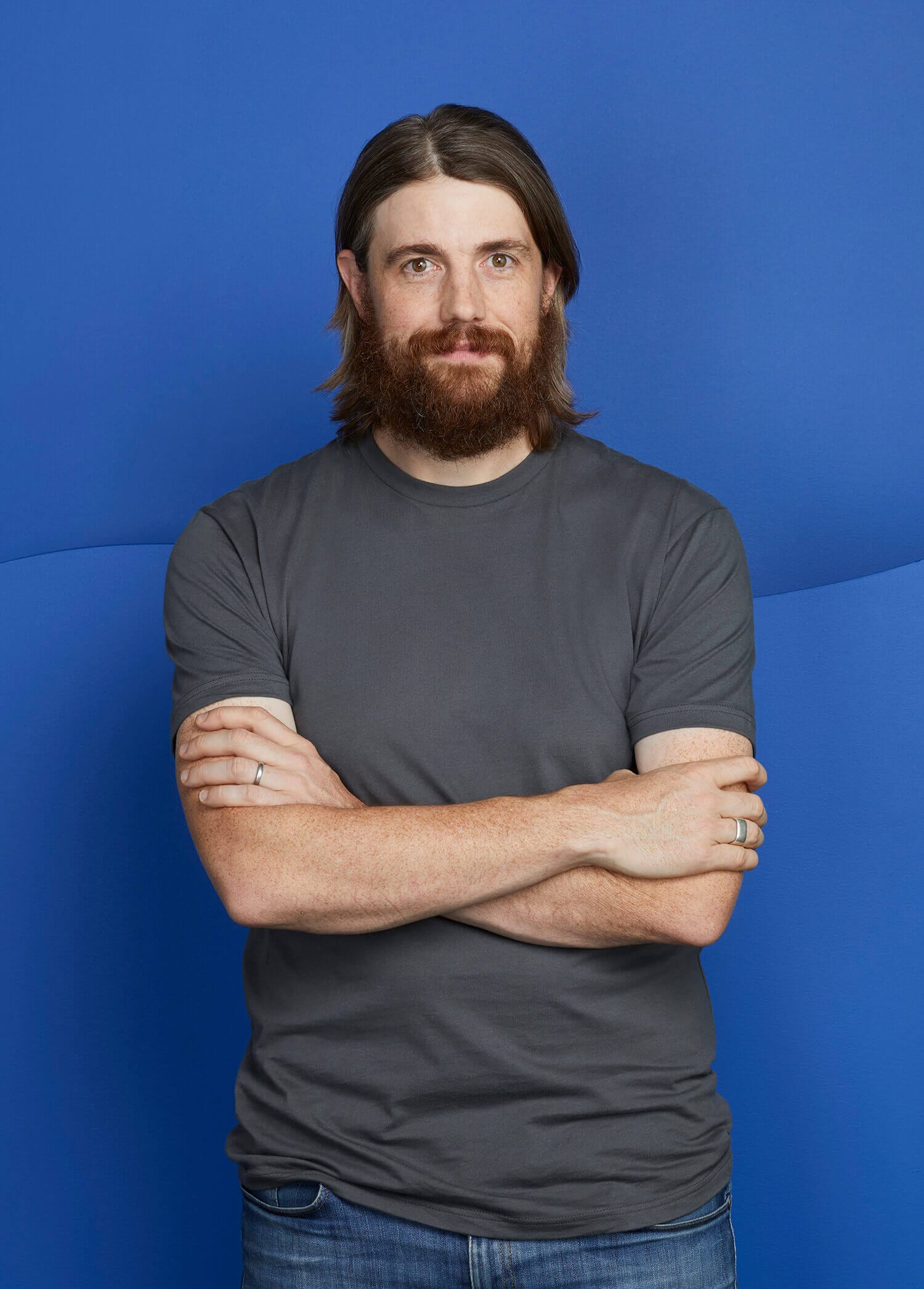 Mike Cannon-Brookes, co-founder and chief executive of Atlassian, arms crossed against a blue background