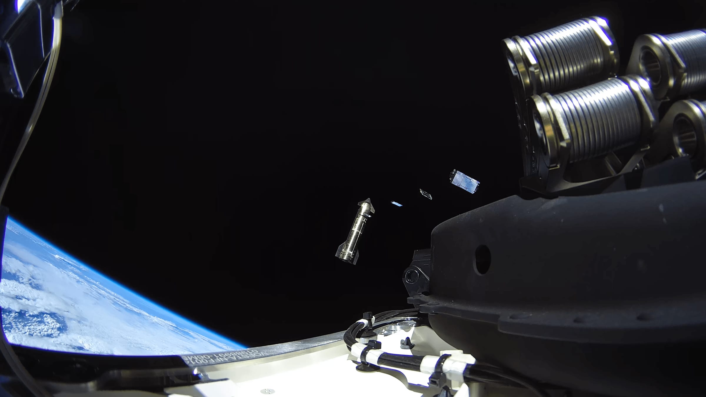 Starship's payload bay open in orbit above Earth's limb as Starlink satellites deploy during Flight 14 on September 28, 2026