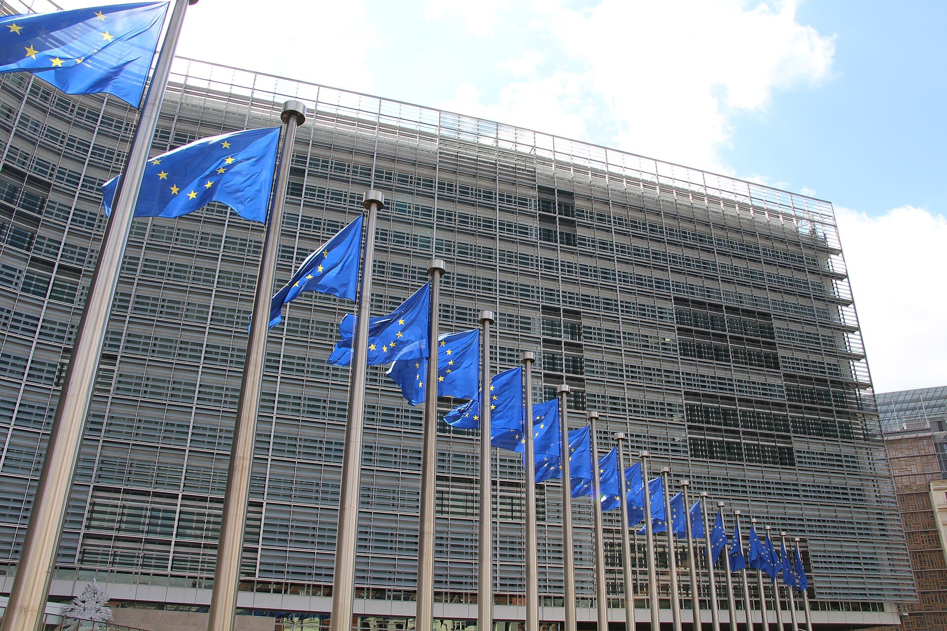 The European Commission's Berlaymont headquarters in Brussels behind a row of EU flags