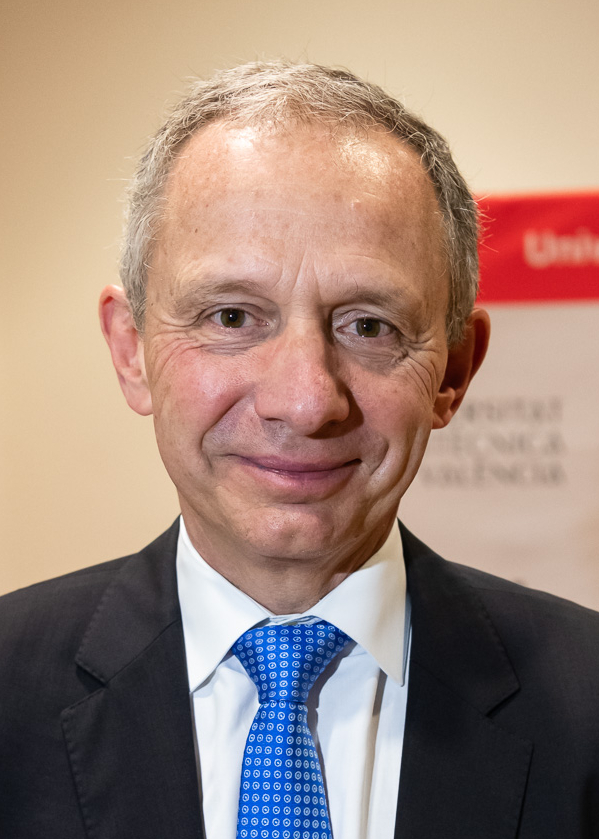 Enrique Lores in a dark suit and blue patterned tie