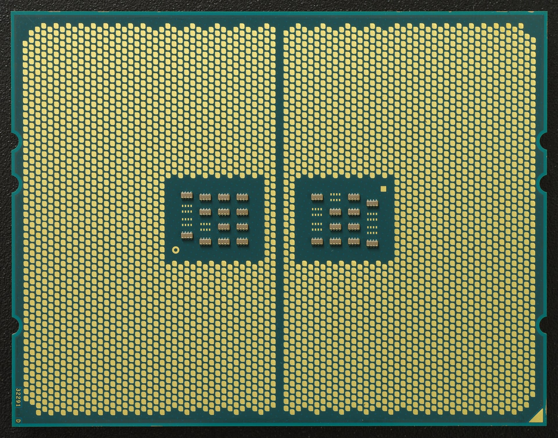 The underside of an AMD EPYC 7302P server processor, a dense grid of gold contact pads set in the green package substrate.
