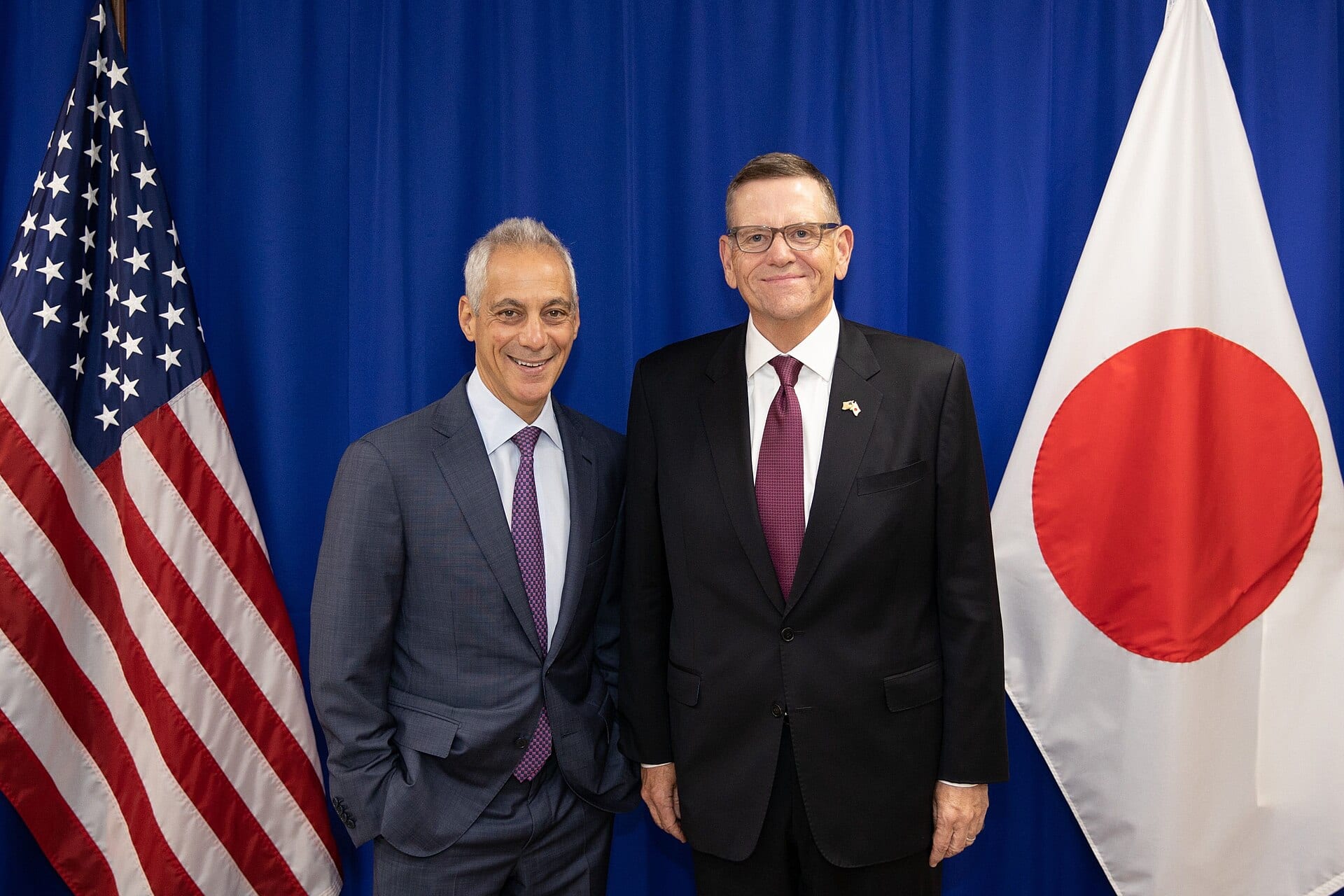 David Goeckeler, chief executive of Sandisk, standing with US ambassador Rahm Emanuel in front of the US and Japanese flags