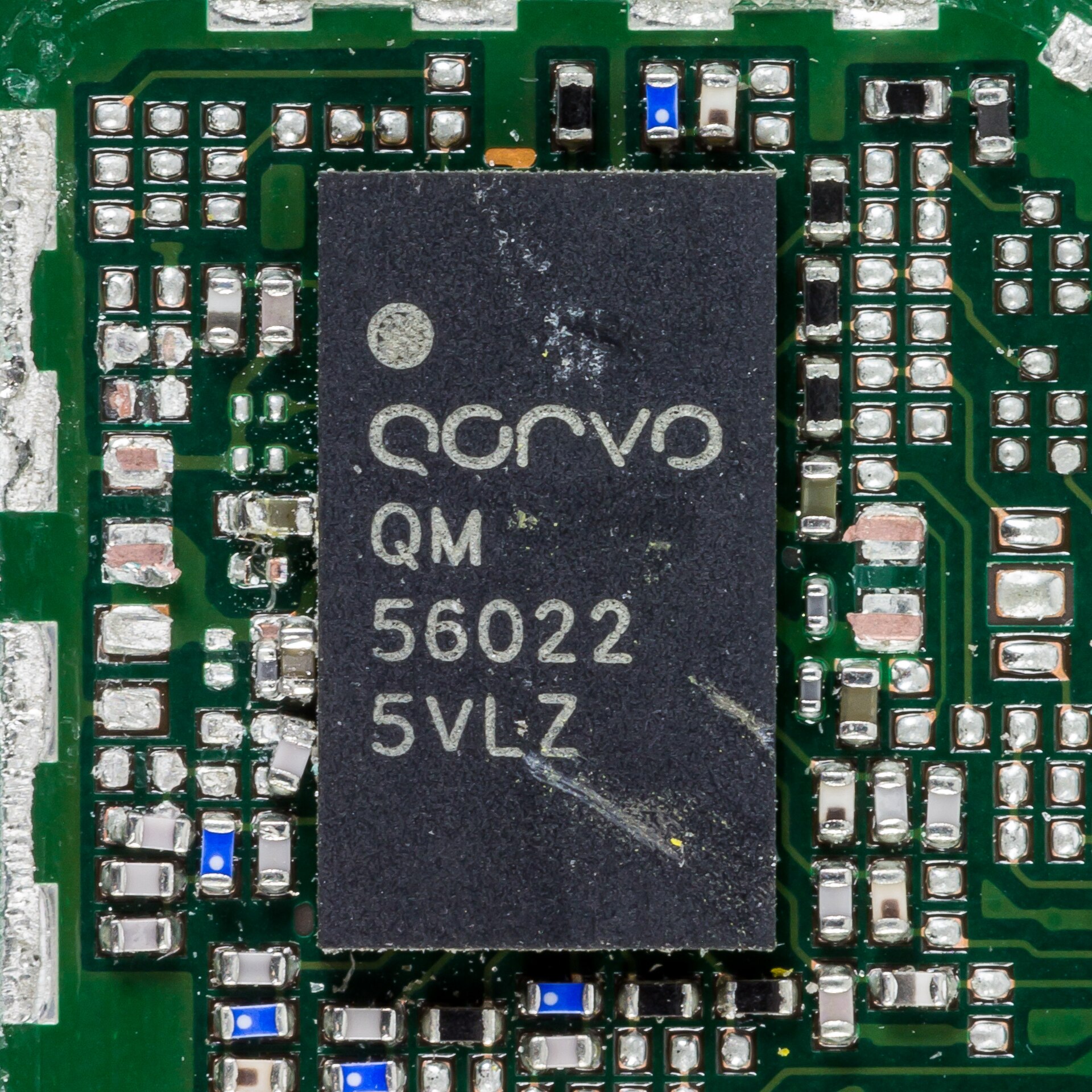 Macro photograph of a Qorvo QM56022 chip on a smartphone main board