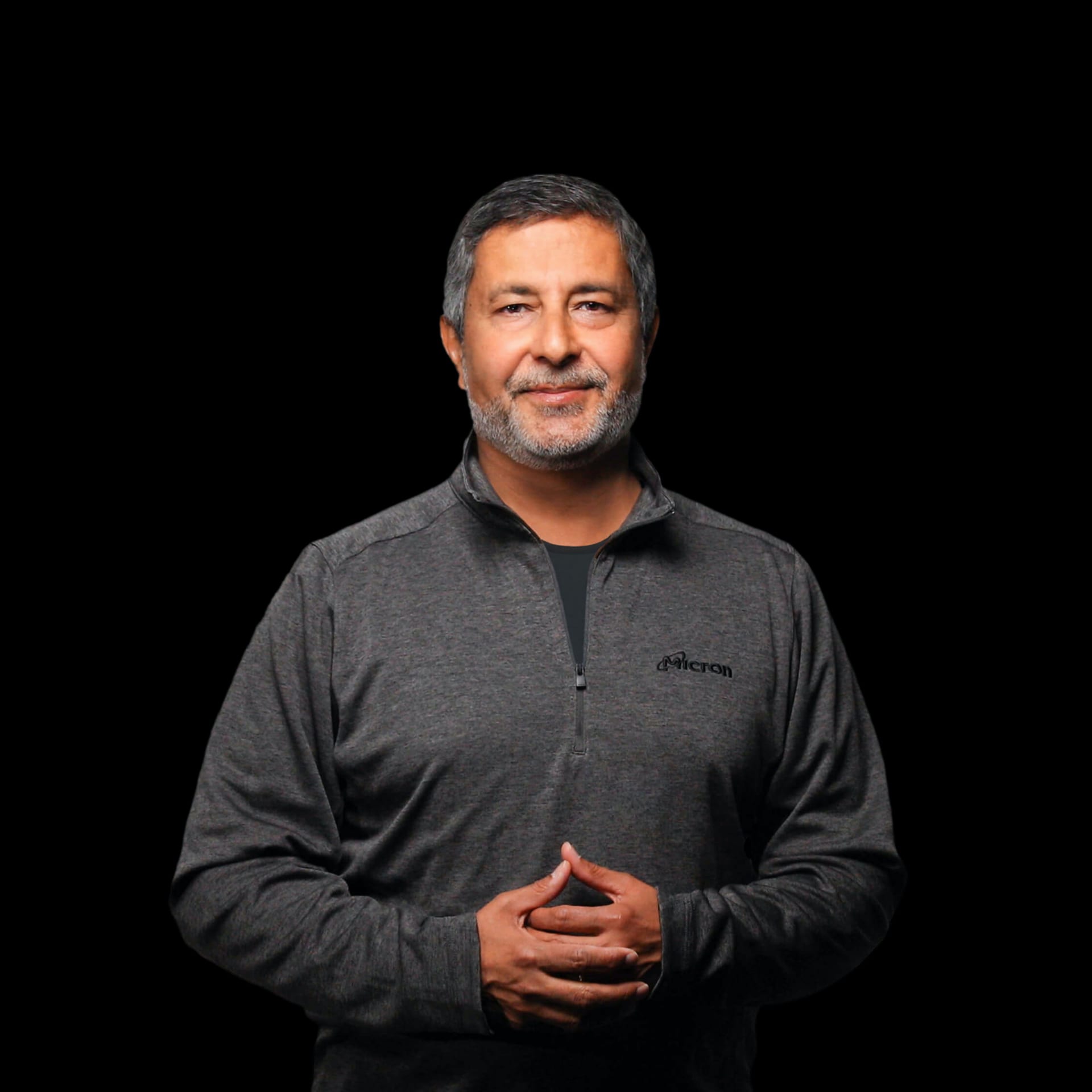 Sanjay Mehrotra, Micron's chairman, president and chief executive, in a studio portrait wearing a Micron pullover