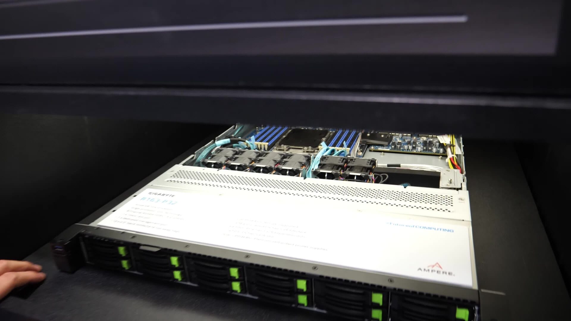 An AI-factory server chassis with exposed compute and memory components at a trade-show exhibition