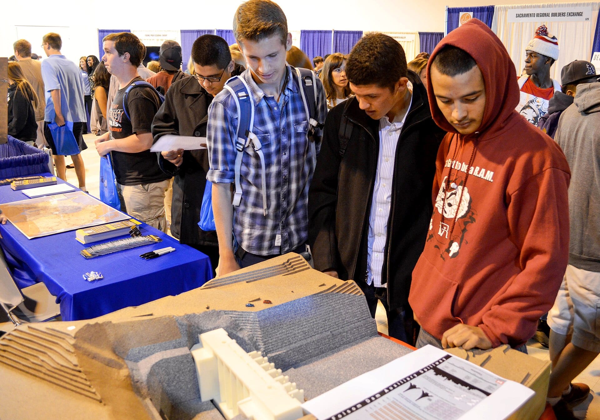 Young job seekers looking at materials at a US Army Corps of Engineers booth during a career fair in Sacramento, California