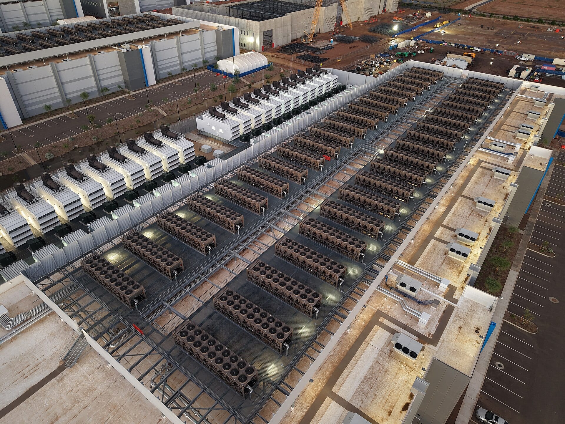Aerial view of rooftop chillers, cooling towers and backup generators covering a large data-center campus under construction