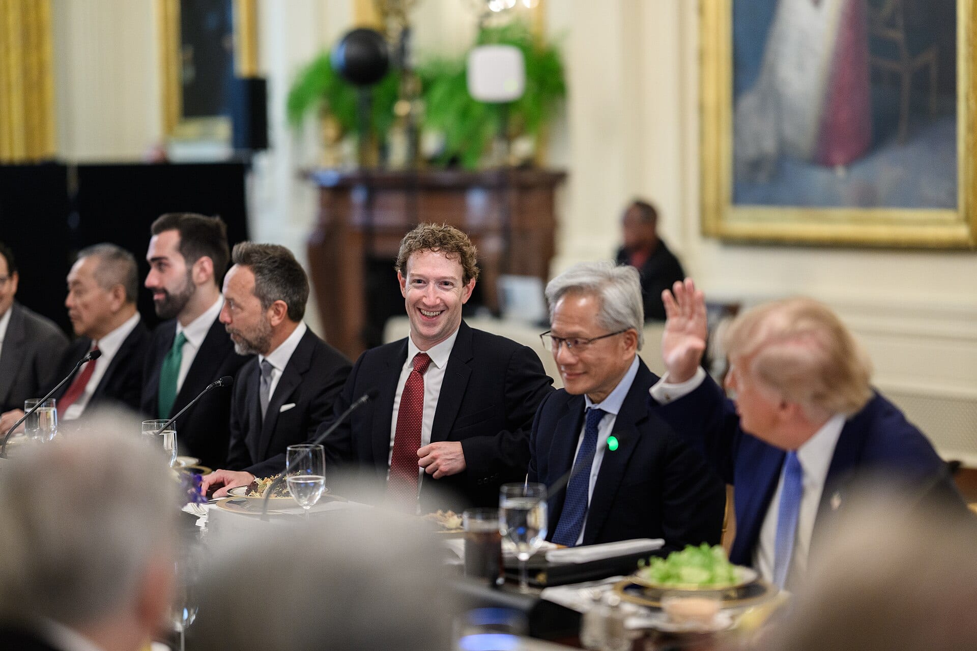 Mark Zuckerberg smiling at a table of tech executives during the White House luncheon on superintelligence