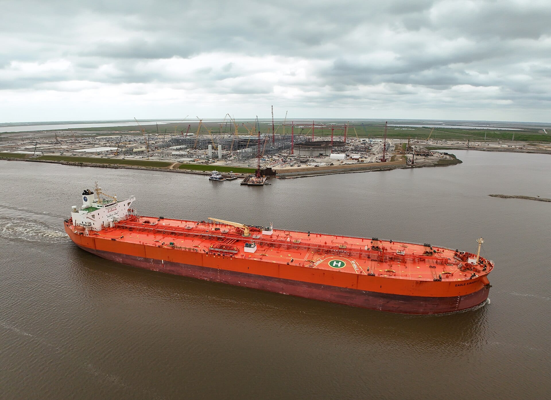 An LNG carrier passes the Port Arthur LNG terminal under construction on the Texas coast