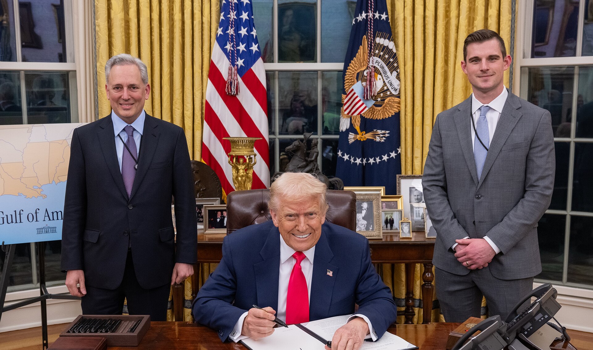 David Sacks, left, stands beside the Resolute Desk as President Trump signs an order in the Oval Office