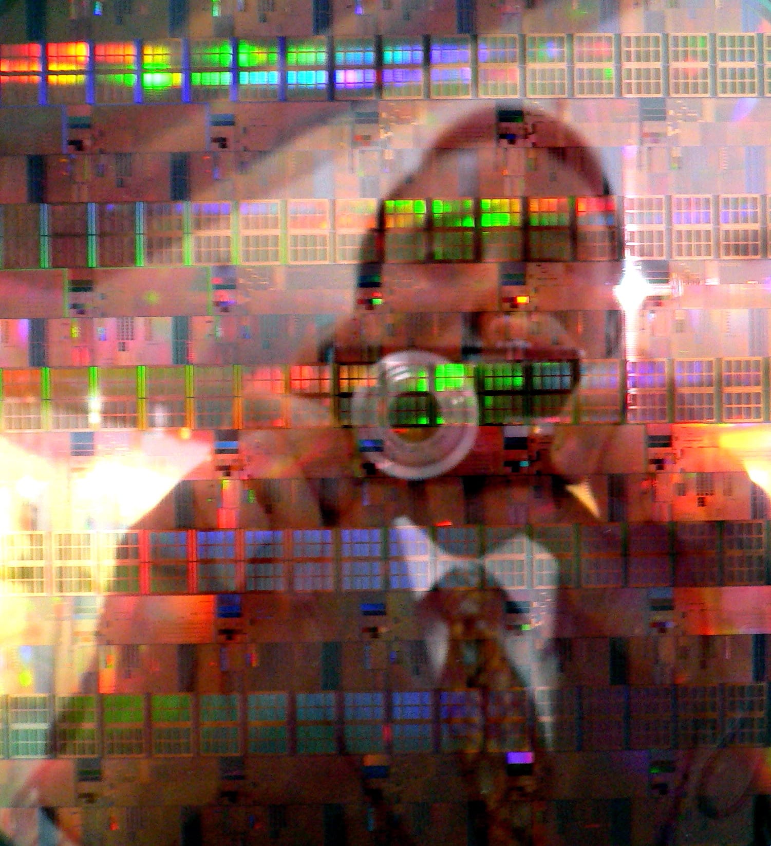 A wafer of printed chips under colored light