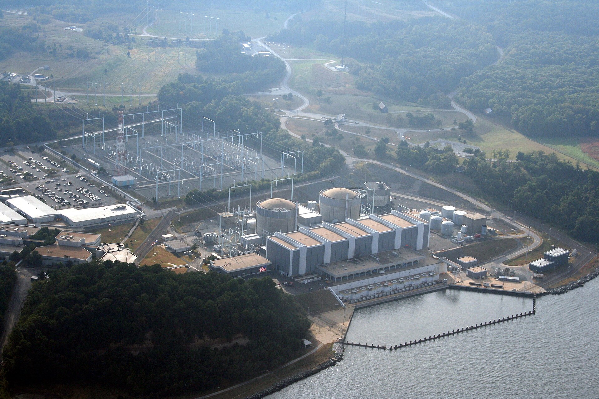 Aerial view of the Calvert Cliffs Nuclear Power Plant, its two containment domes and switchyard on the shore of the Chesapeake Bay.