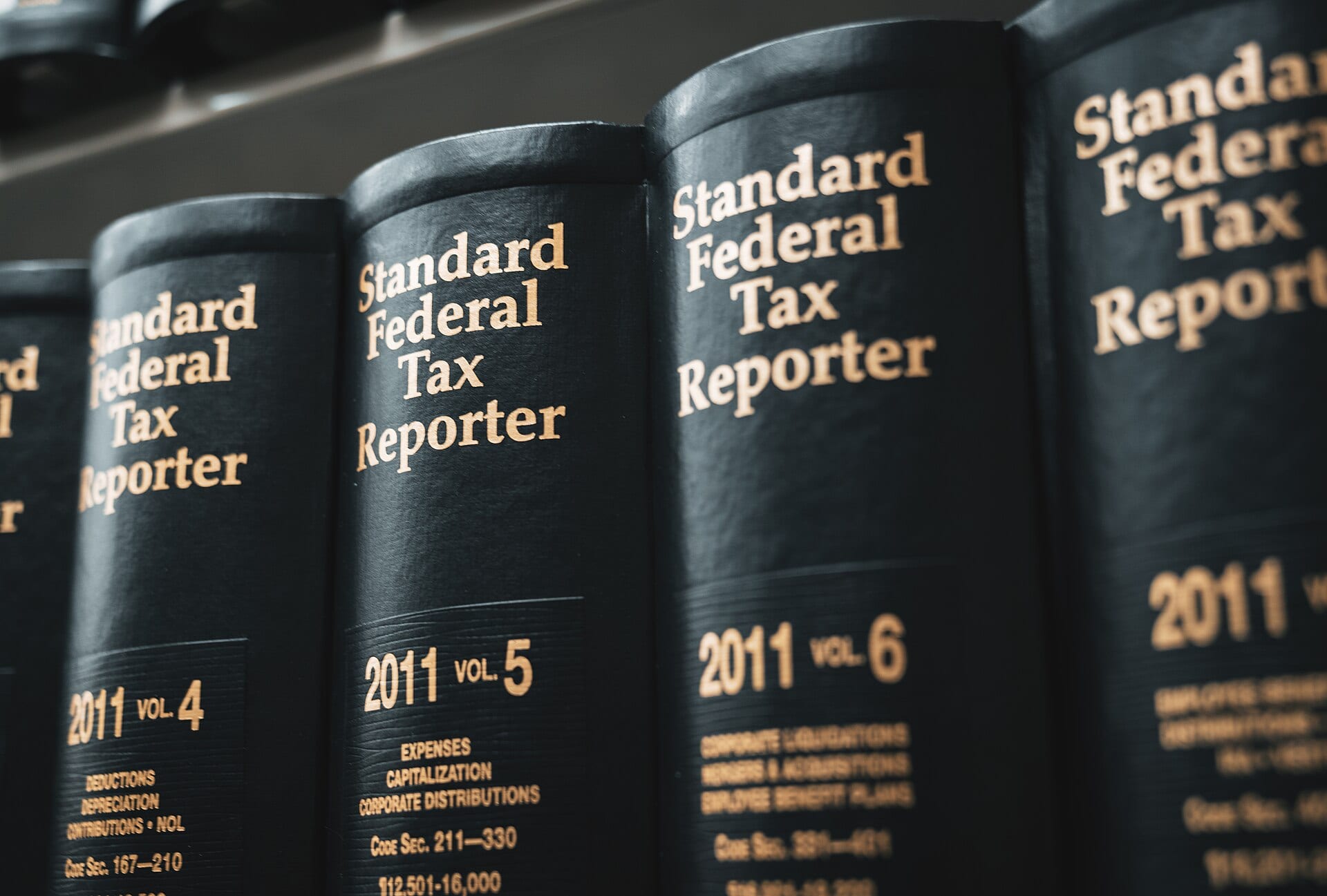 Leather-bound Standard Federal Tax Reporter volumes lined up on a law library shelf