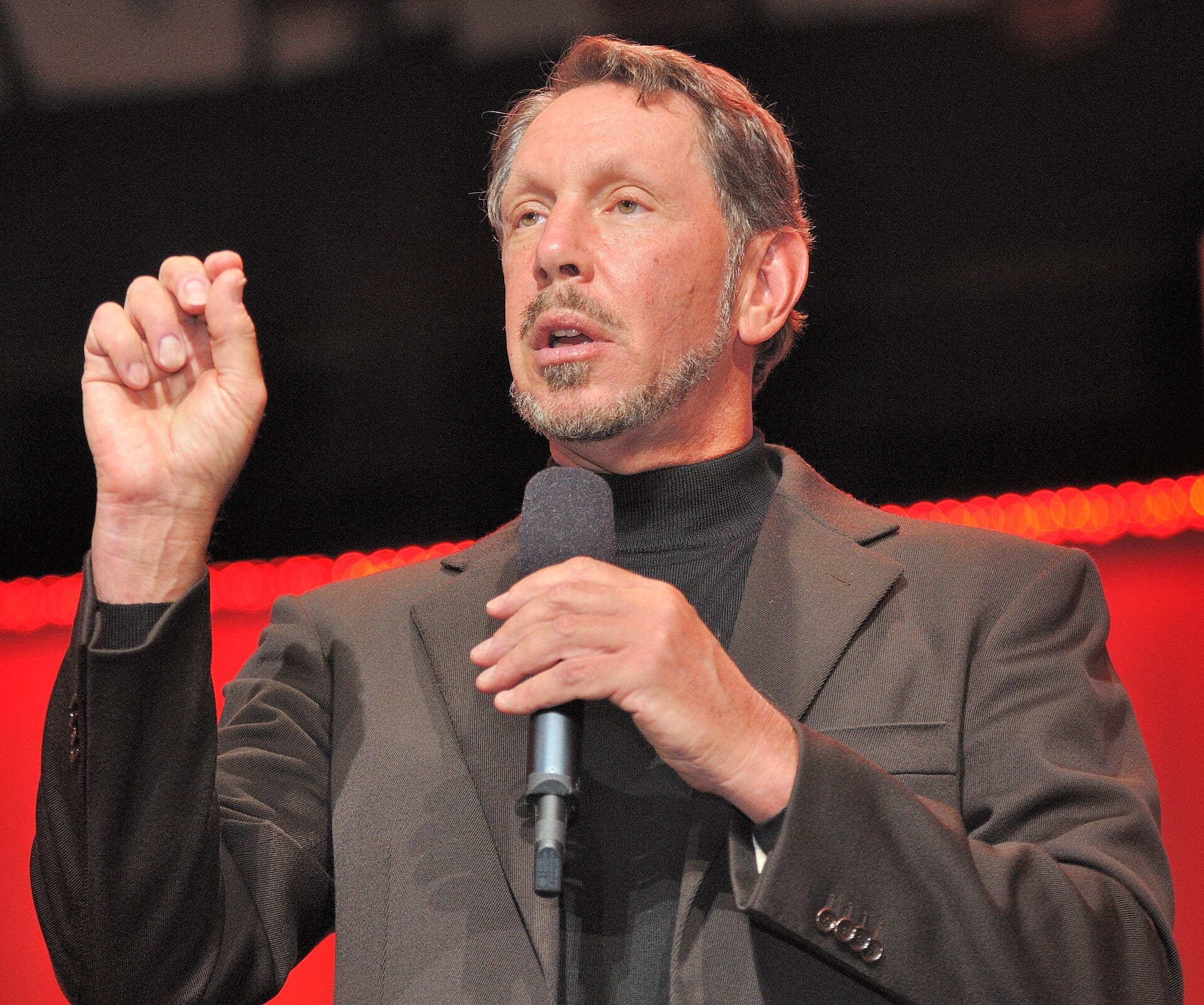 Larry Ellison speaking on stage at an Oracle event