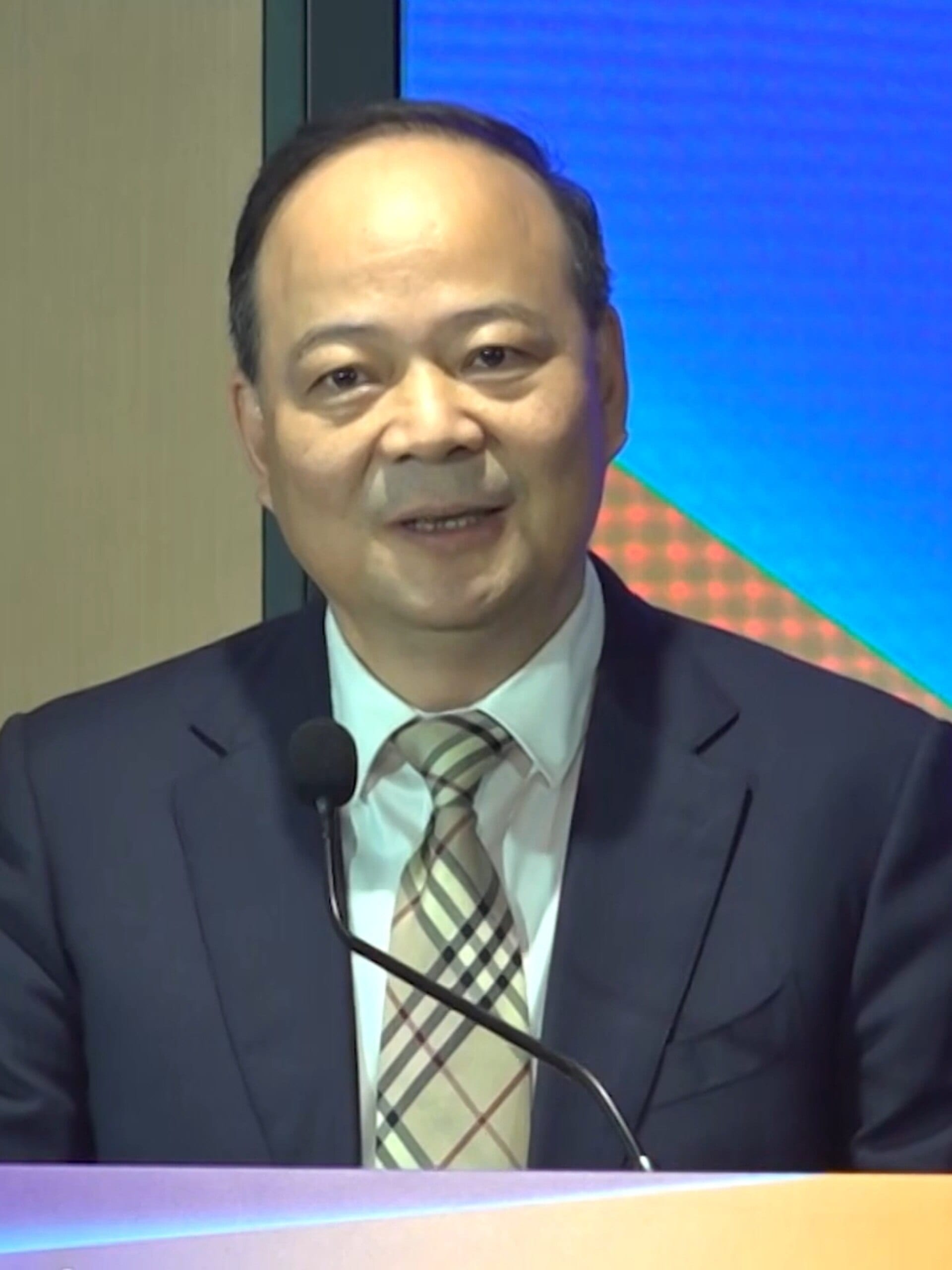 CATL founder and chairman Robin Zeng speaking at a podium