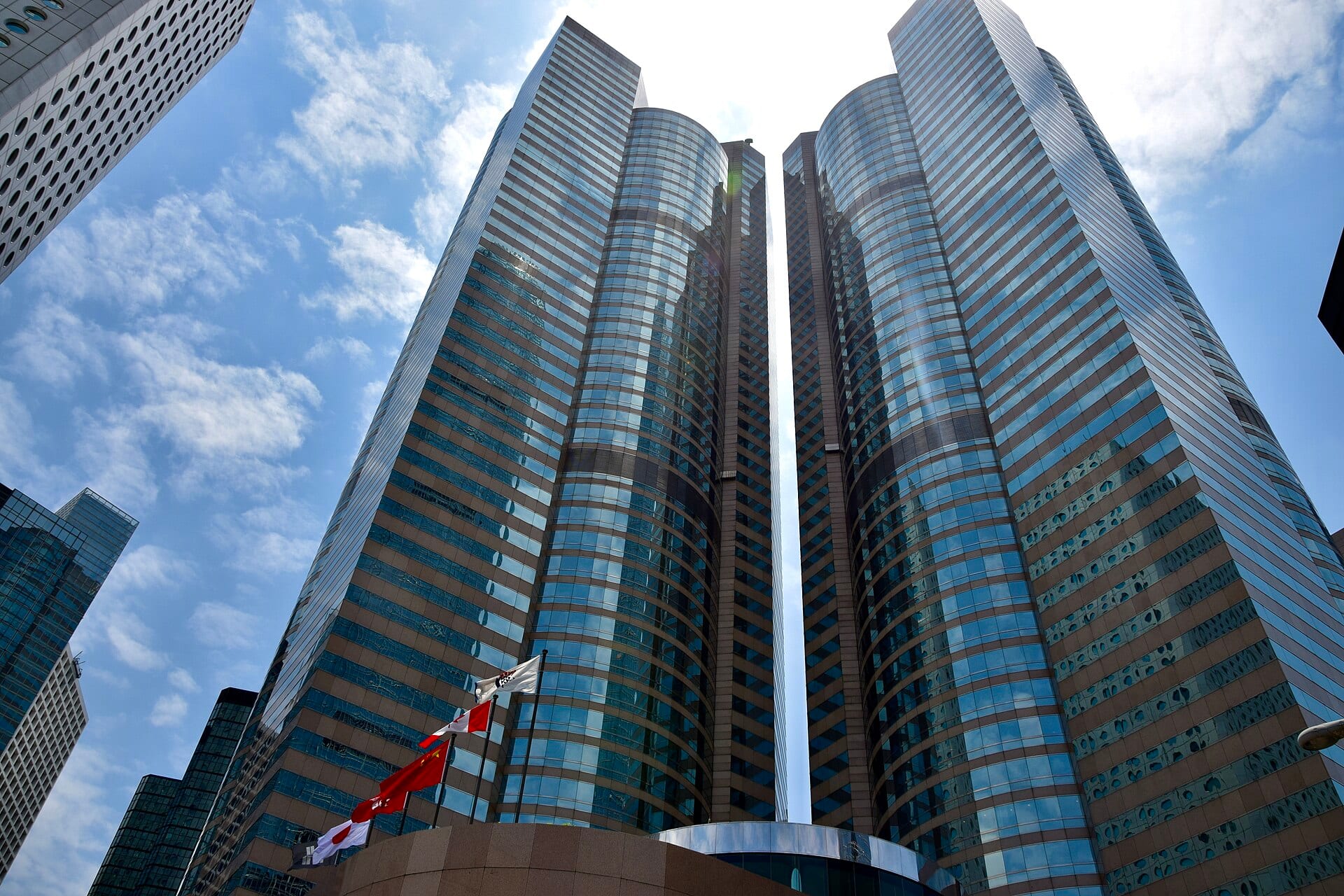Exchange Square in Central, Hong Kong, home of the Hong Kong Stock Exchange, photographed from below against a blue sky