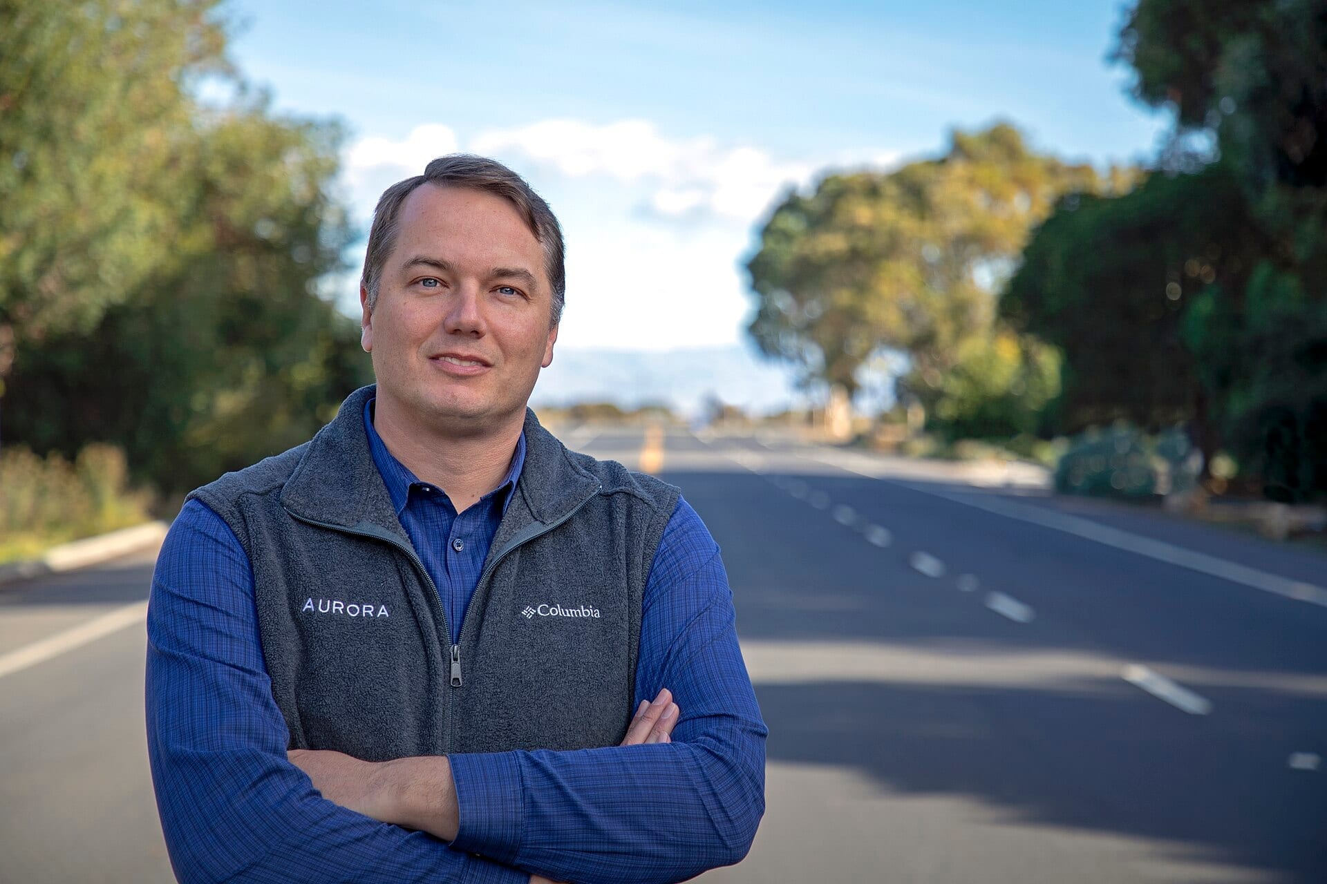 Chris Urmson, chief executive of Aurora Innovation, standing on an empty highway