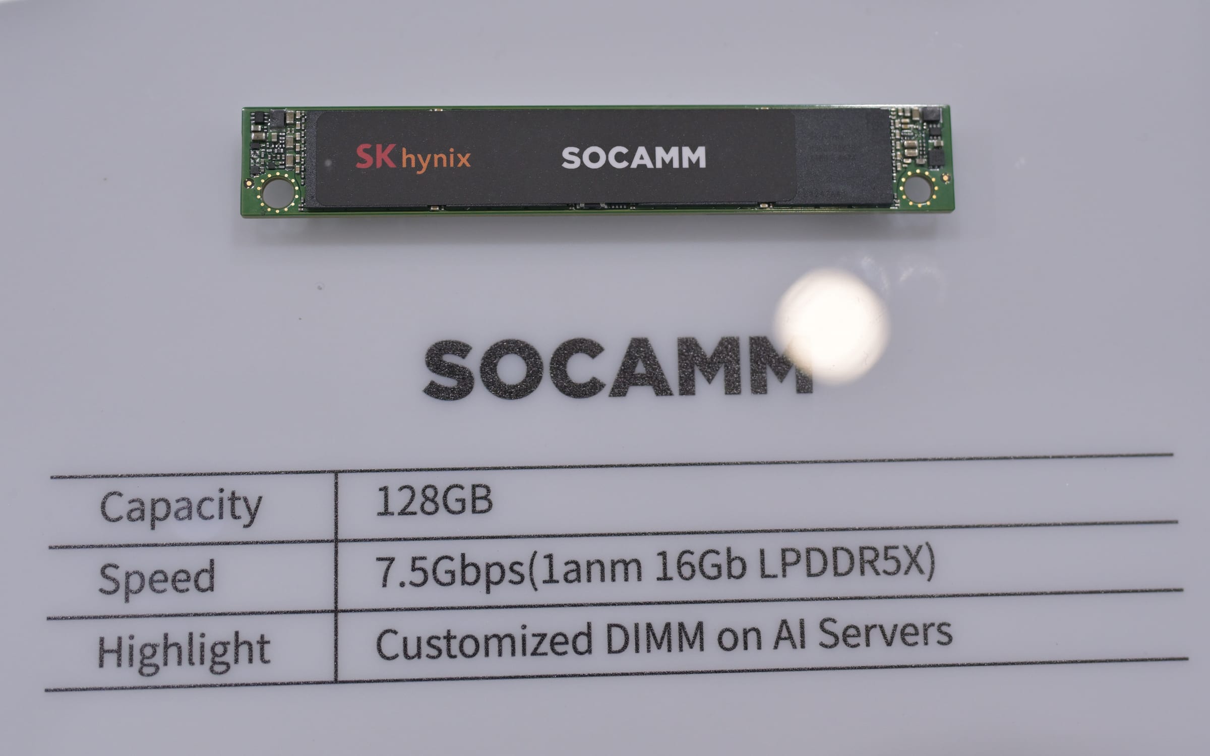 An SK hynix SOCAMM memory module for AI servers on display at Computex 2025, with a placard listing 128GB capacity and 7.5Gbps speed.