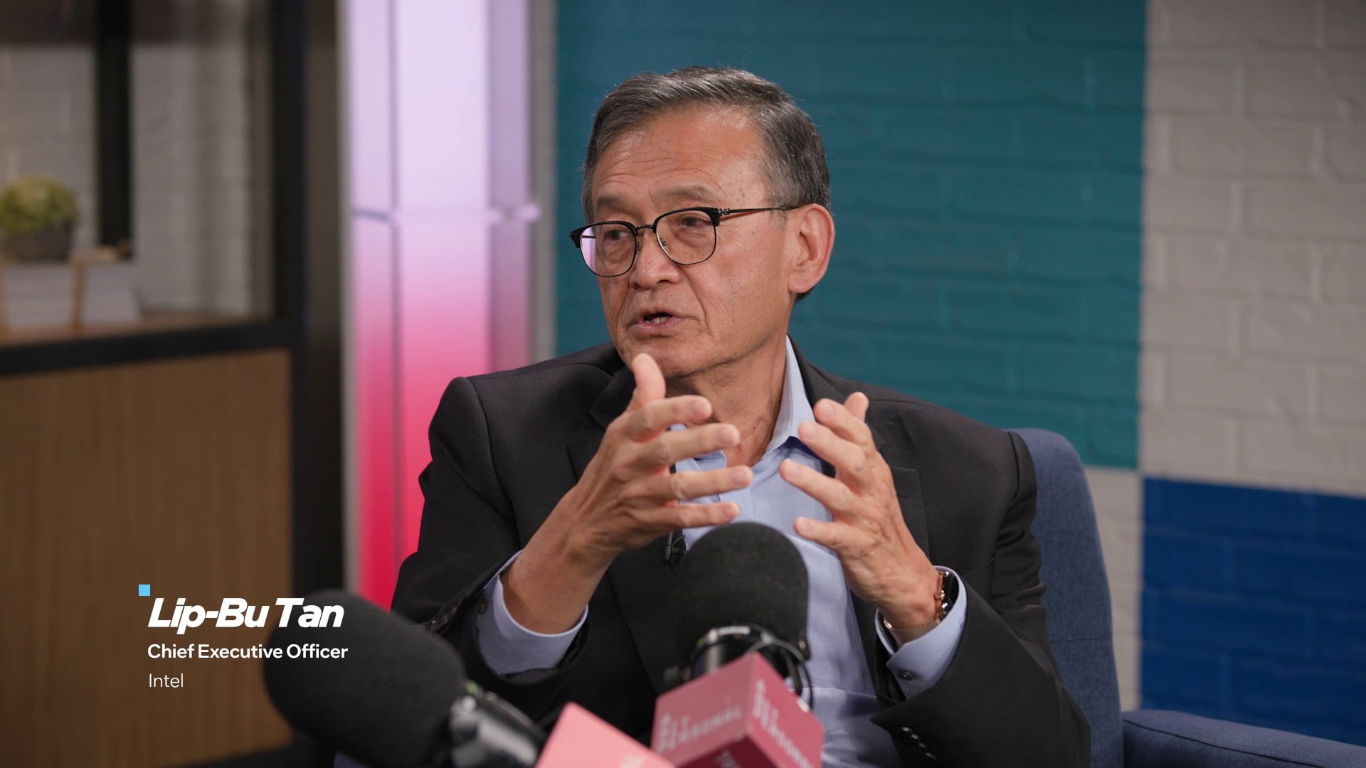 Intel chief executive Lip-Bu Tan speaks during an interview, gesturing with both hands, with an on-screen caption identifying him as chief executive officer of Intel