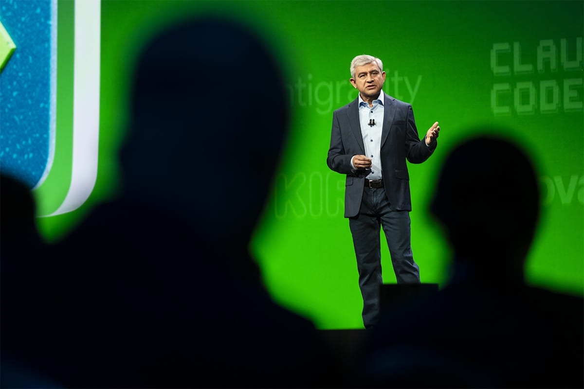 Amit Zavery, ServiceNow's president, chief product officer and COO, speaking on stage at Knowledge 2026, seen past the silhouettes of the audience