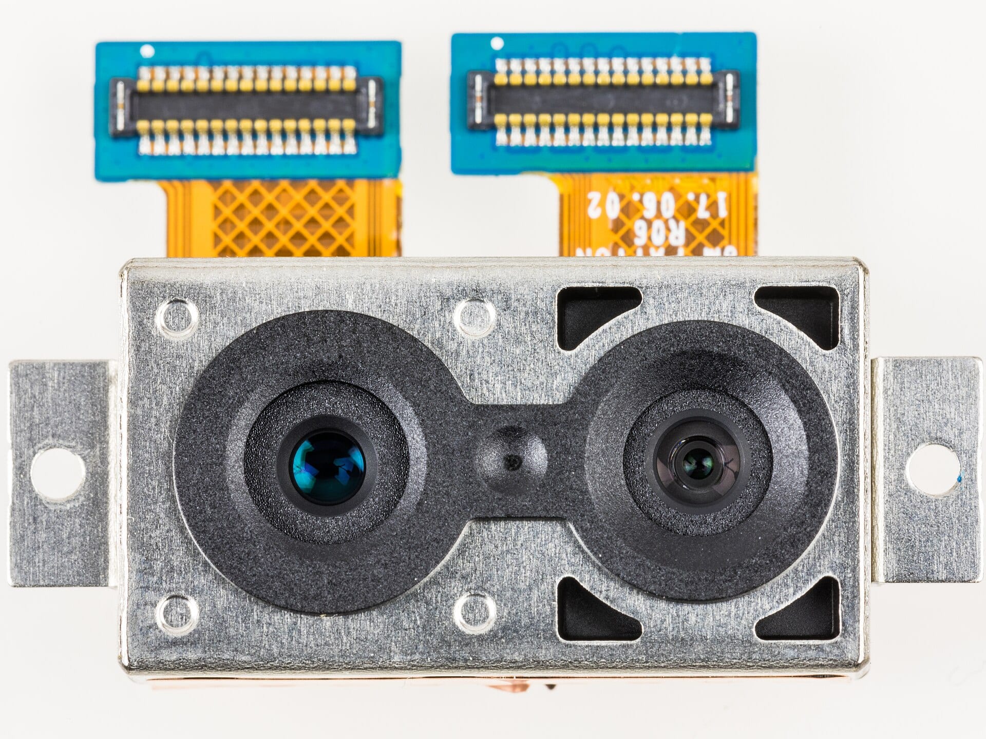Macro photograph of a dual-lens smartphone camera module with its flexible circuit connectors