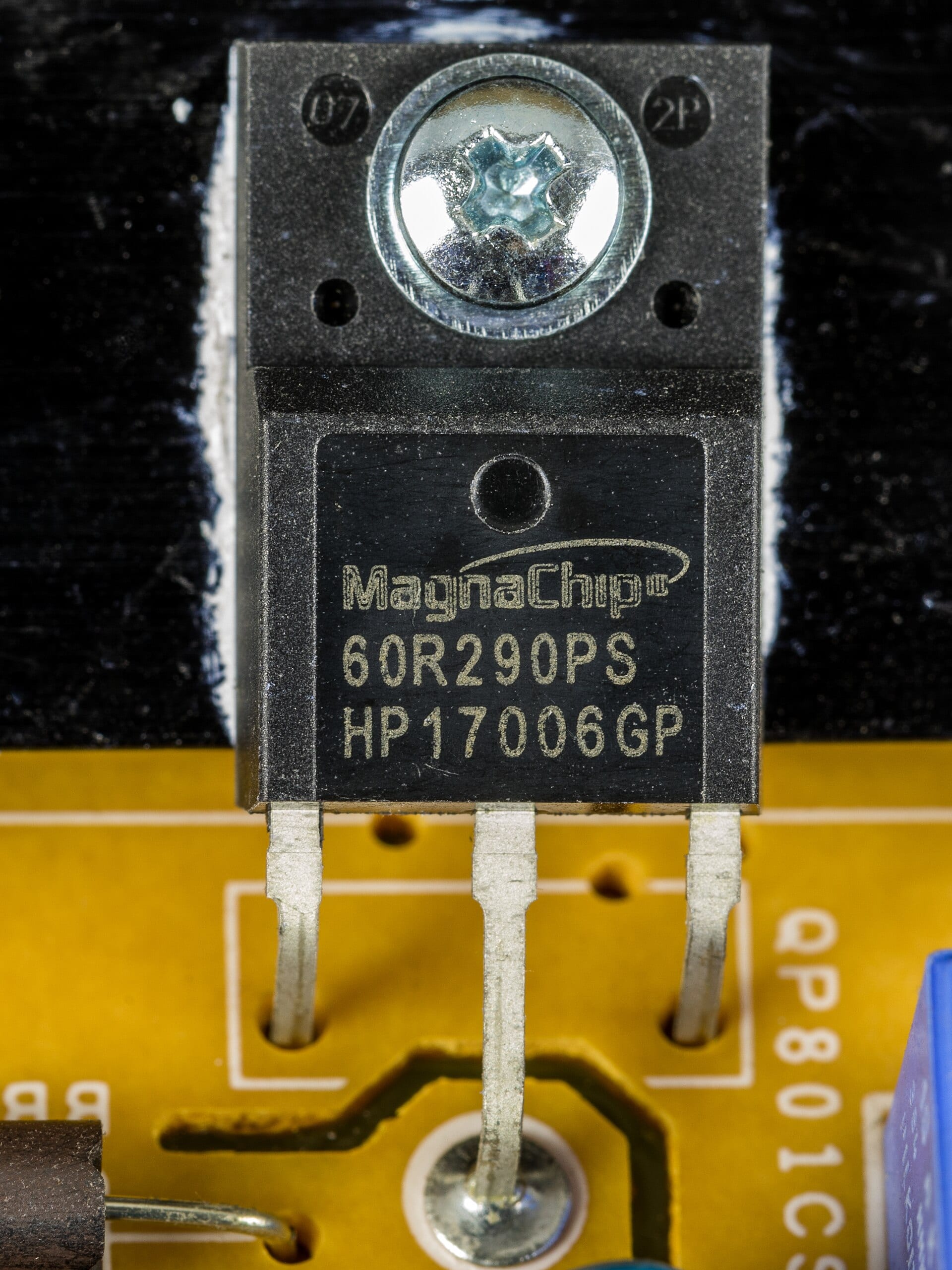 Close-up of a MagnaChip-brand power semiconductor soldered to a television power-supply board