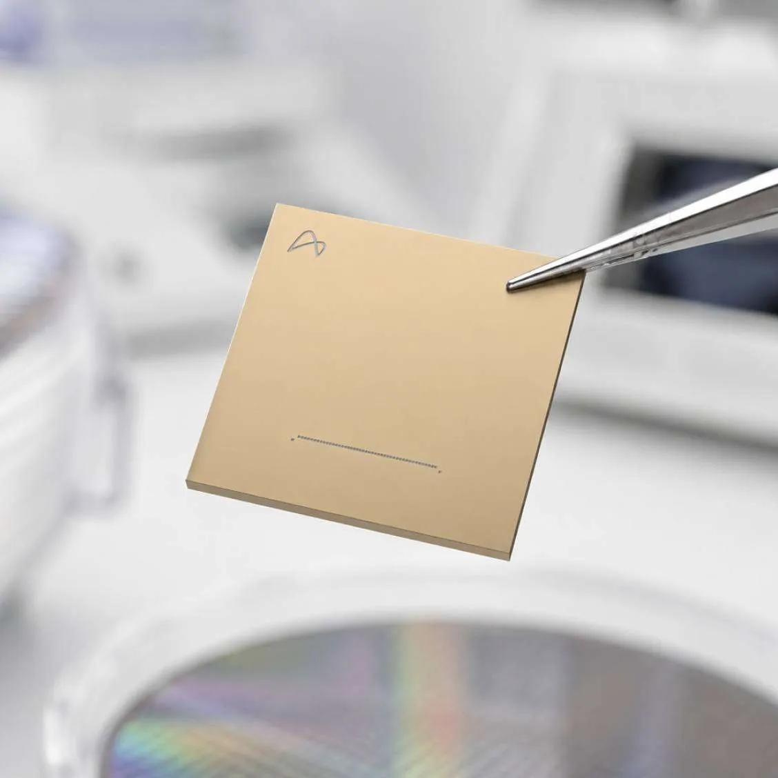 A TeraPHY optical engine chip held by tweezers in Ayar Labs' lab