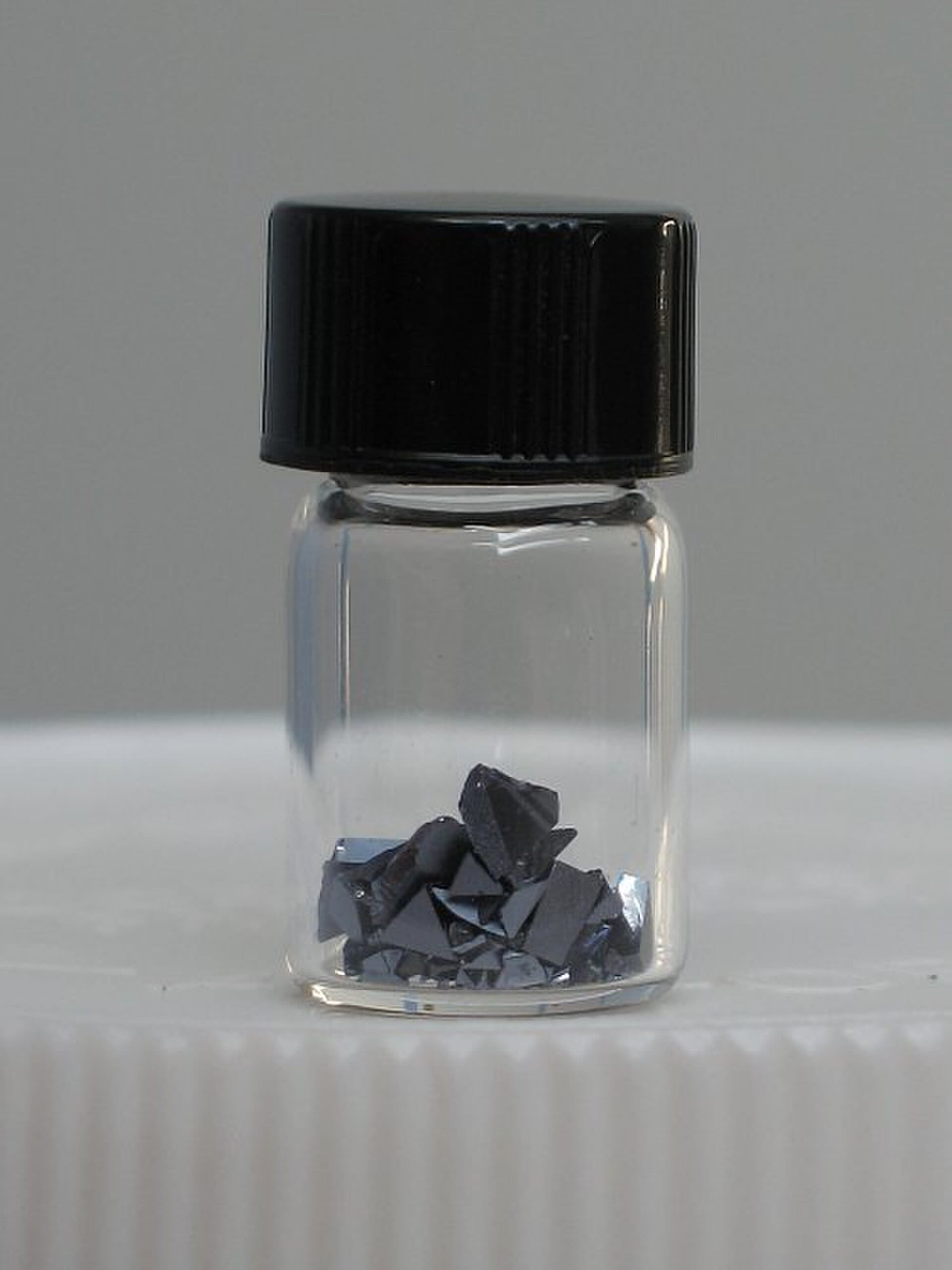 A polished square plate of indium phosphide, the semiconductor compound AXT grows into substrates in China