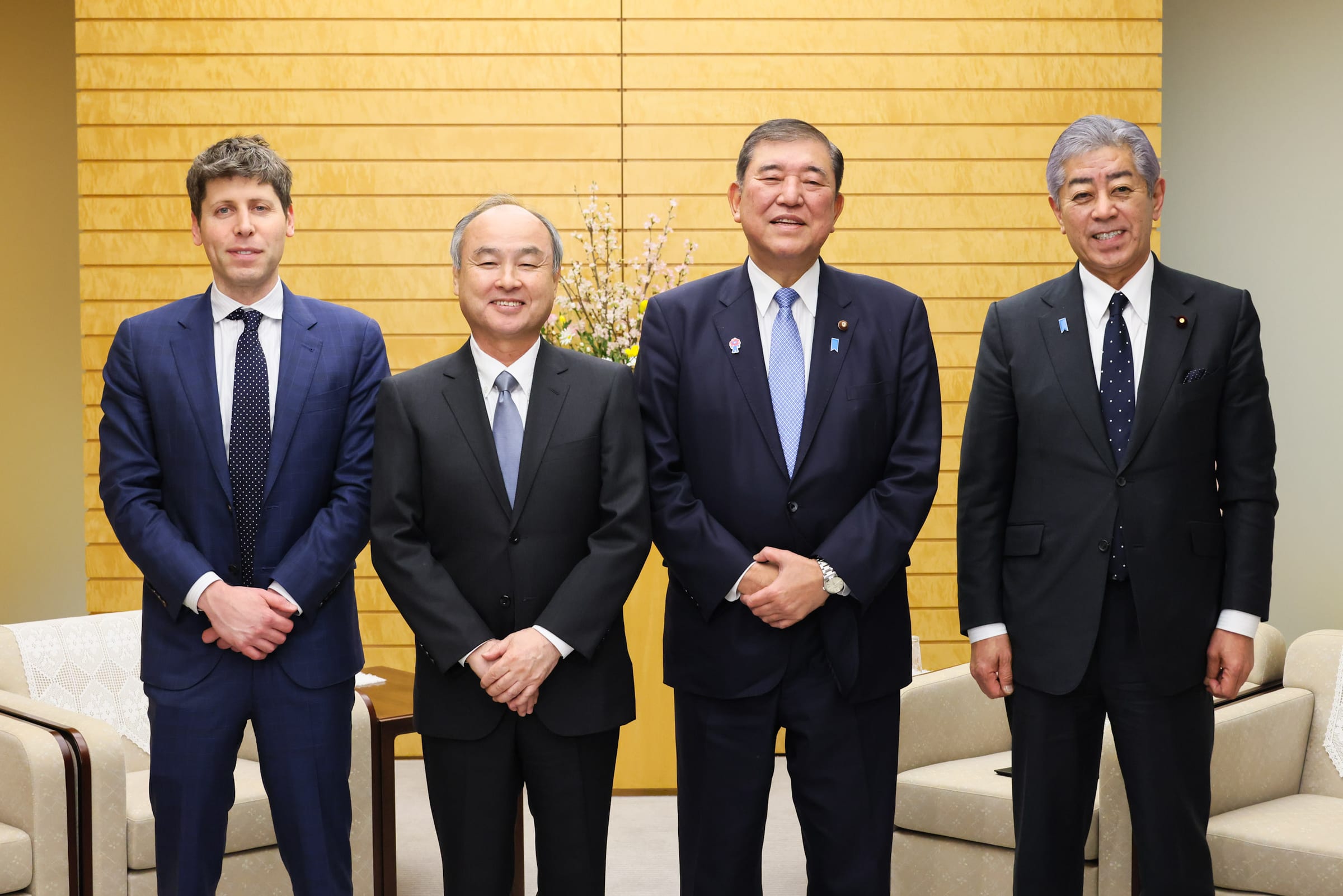 Masayoshi Son and Sam Altman standing with Japanese Prime Minister Shigeru Ishiba and Foreign Minister Takeshi Iwaya at the prime minister's office in Tokyo, February 2025.