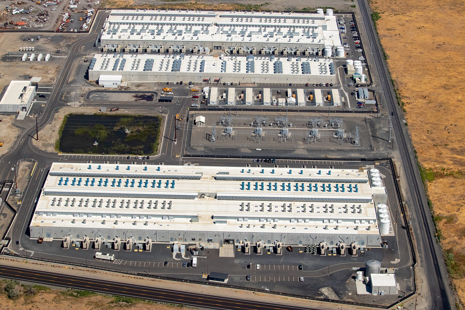An aerial view of an Amazon Web Services data center campus and its electrical substation