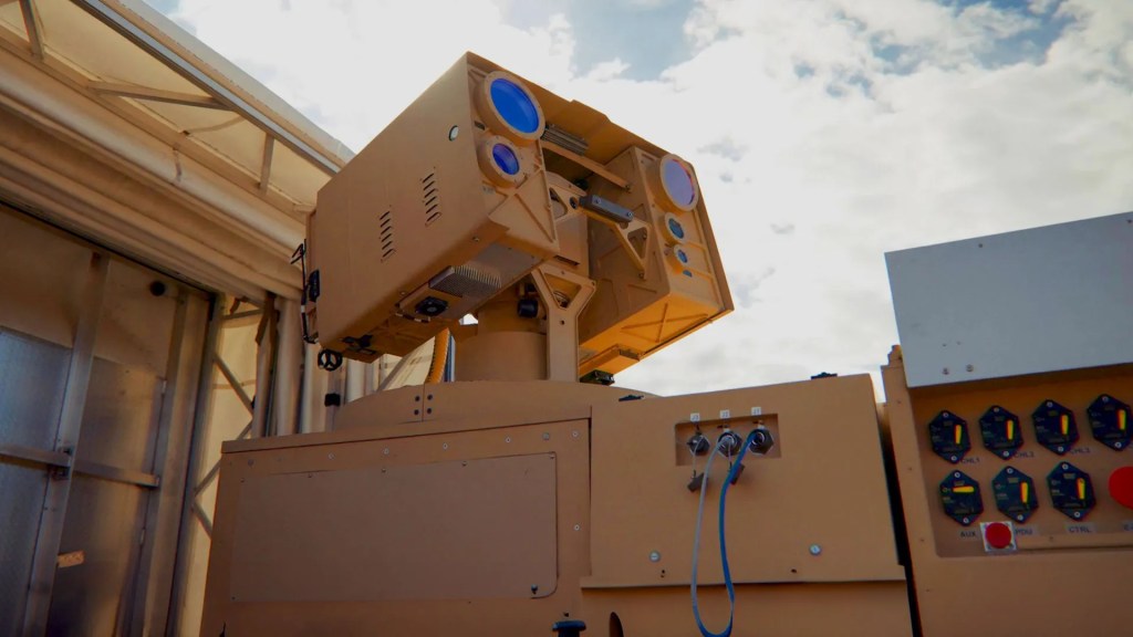 AeroVironment's LOCUST laser turret on a mount beside its control panels