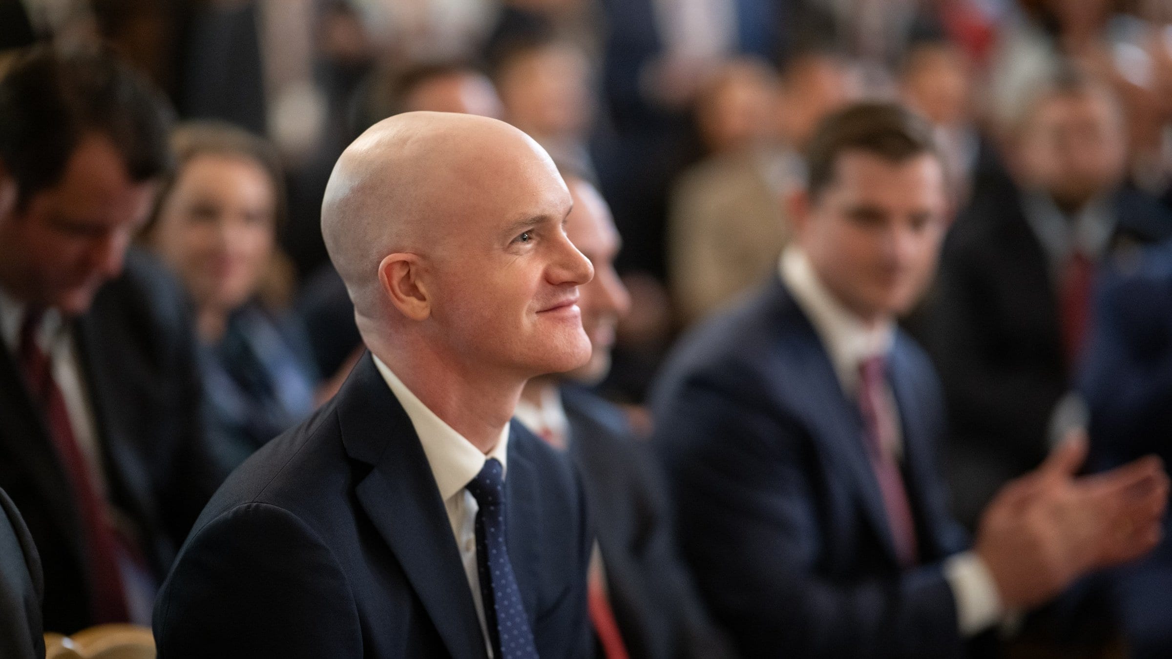 Brian Armstrong in the East Room audience as President Trump signs the GENIUS Act stablecoin law, 18 July 2025