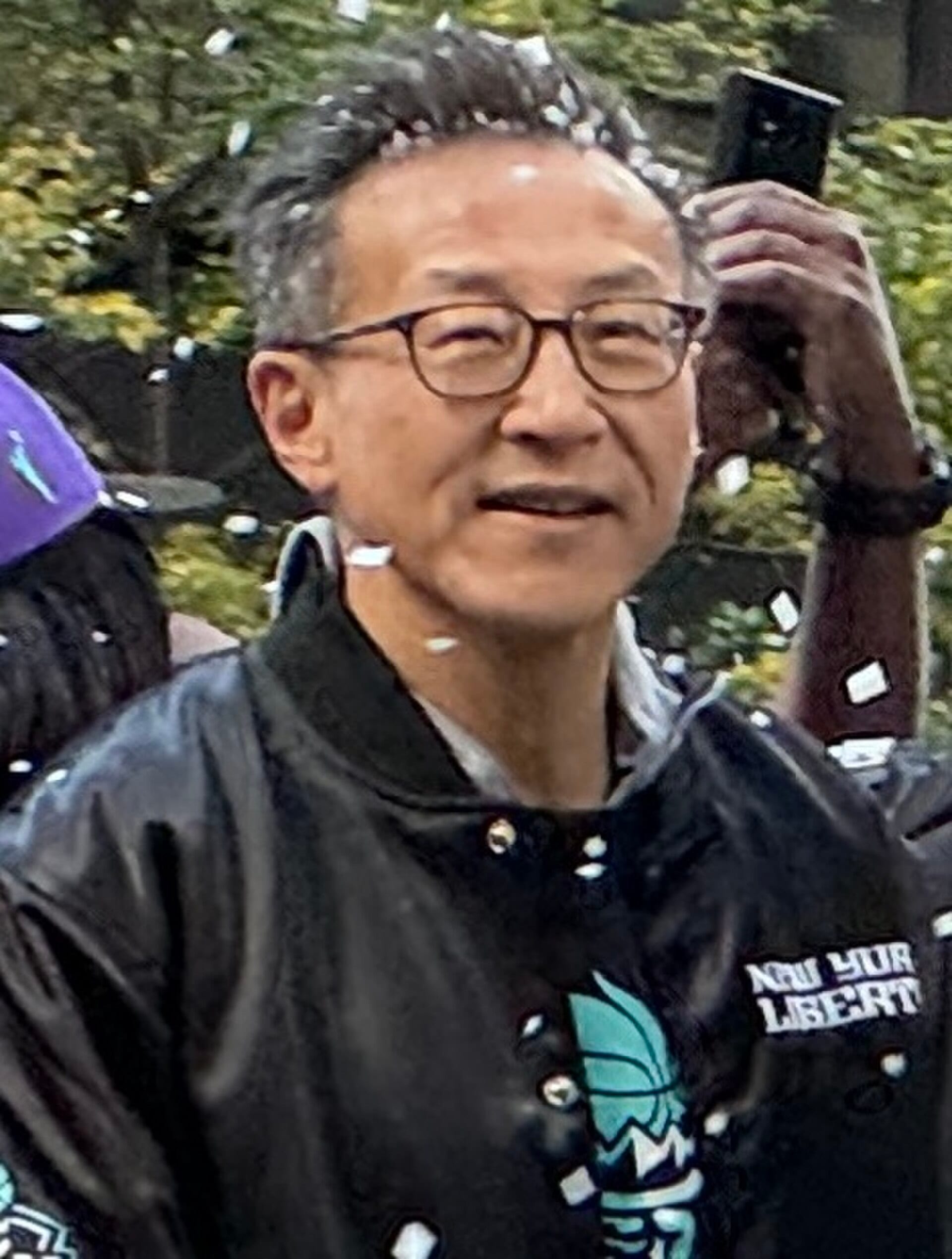 Joe Tsai, chairman of Alibaba Group, in a New York Liberty jacket at the team's championship ticker tape parade