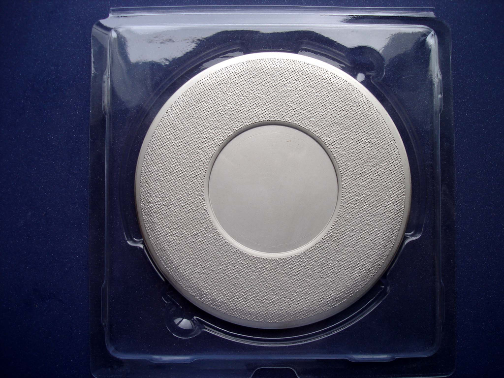 A CMP-108 diamond pad conditioner disk, a consumable used in chemical mechanical polishing equipment, in its plastic packaging