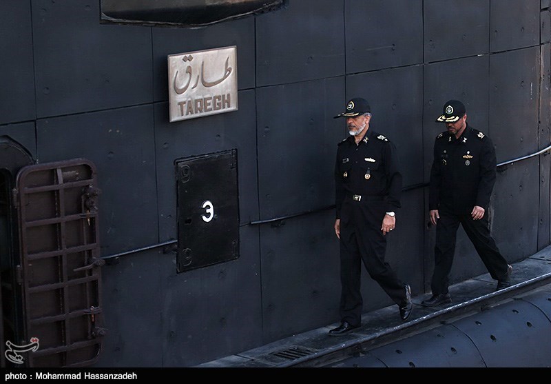 Iranian officials beside the submarine Tareq at Bandar Abbas naval base during a 2014 presidential visit