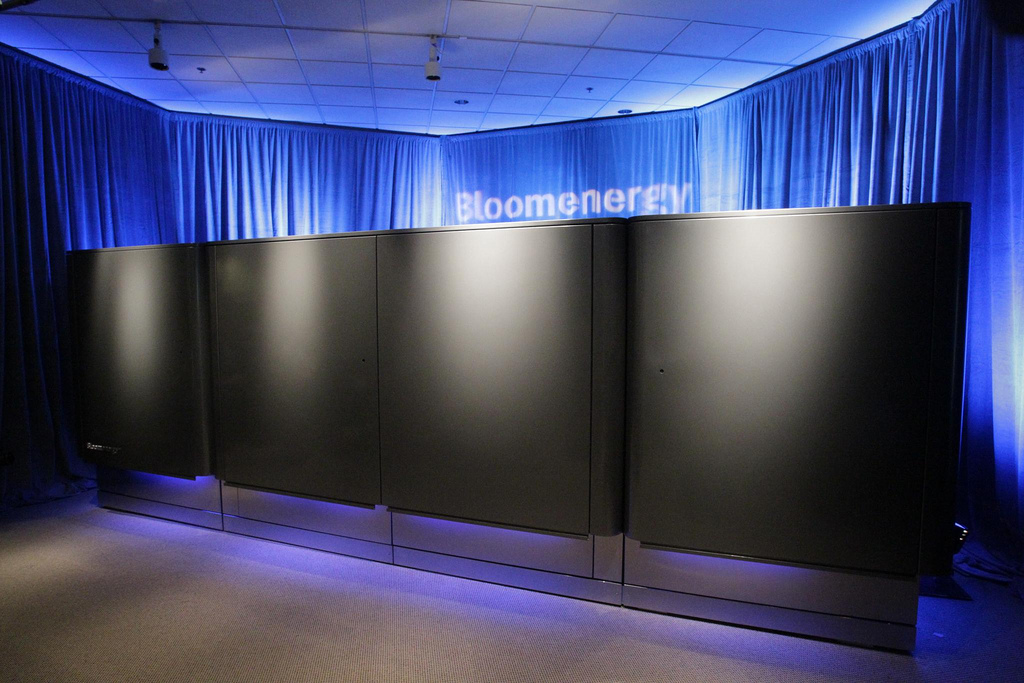 A row of Bloom Energy fuel cell servers under blue lighting at the company's 2010 launch event